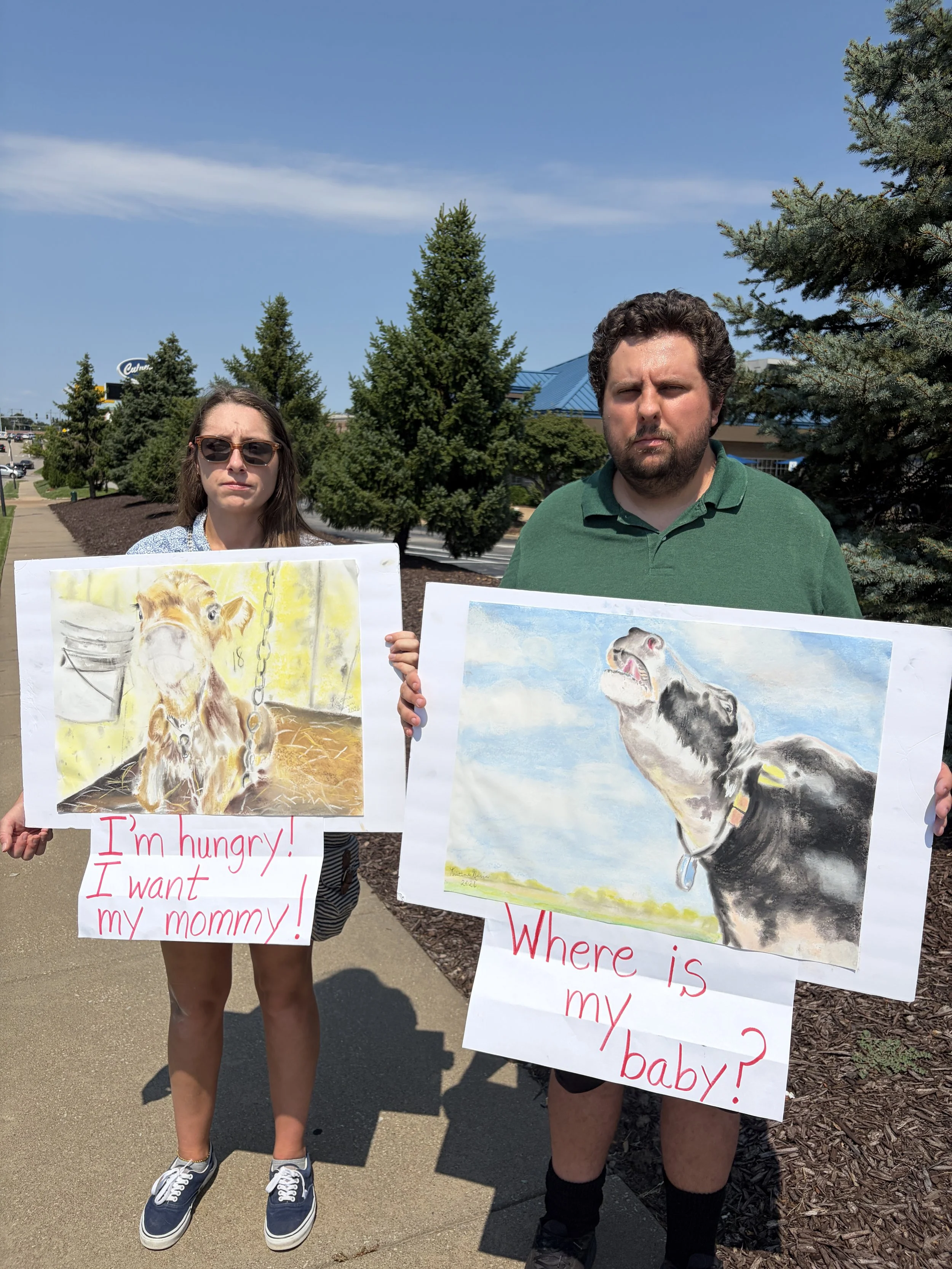 Vic and Kyle hold up artwork for Dairy Is Scary Protest at Culver_s in St. Louis, Missouri.png