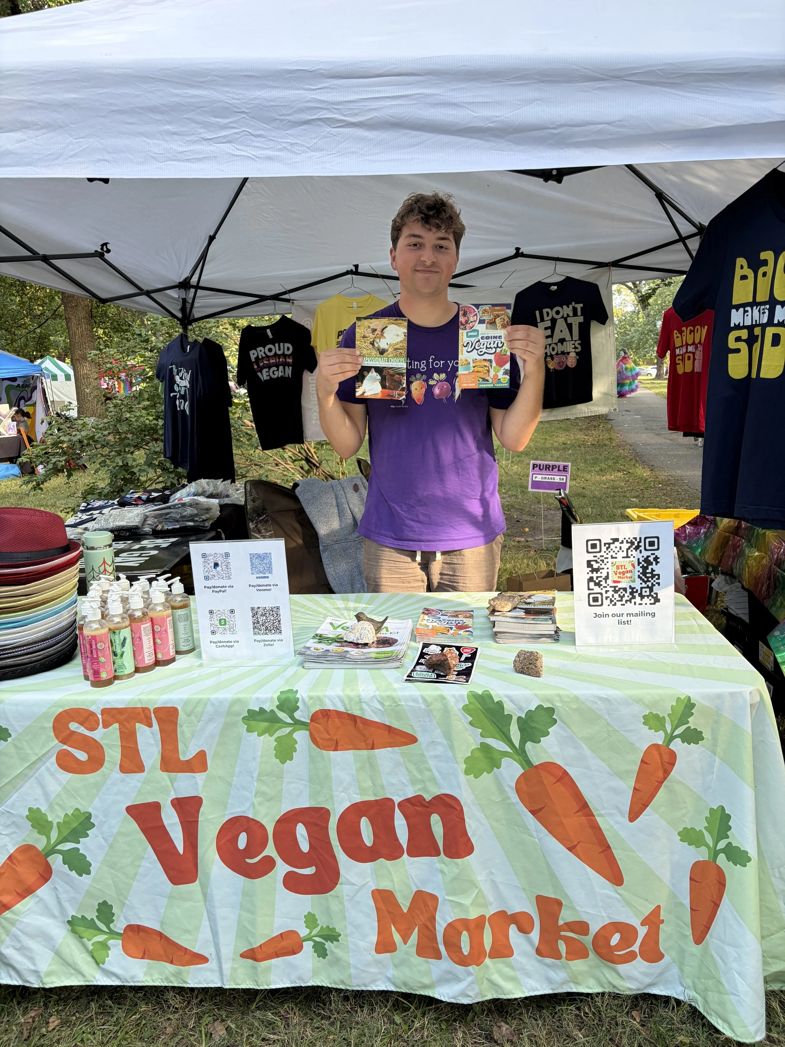 Troy displays animal rights literature for Vegan Pride Booth at Tower Grove Pride in St. Louis, Missouri.png
