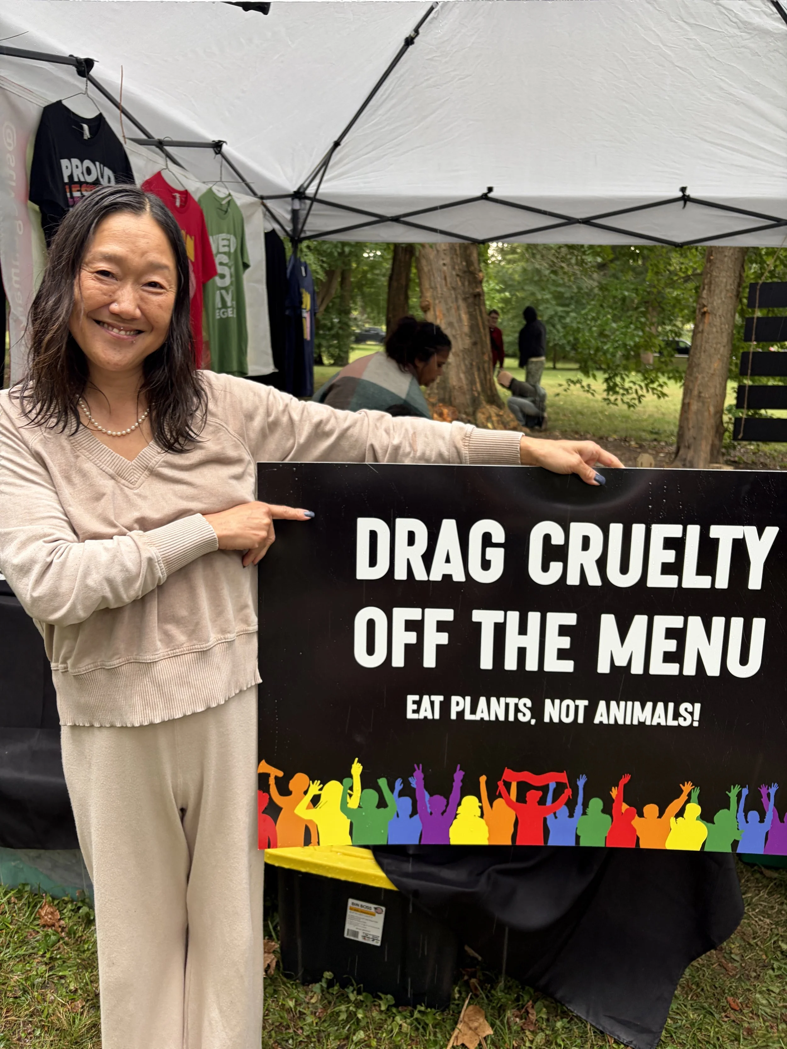 Booth guest holds Drag Cruelty off the Menu for Vegan Pride Booth at Tower Grove Pride in St. Louis, Missouri (1).png