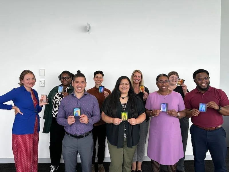 Group of people at an event together holding their aura photos .