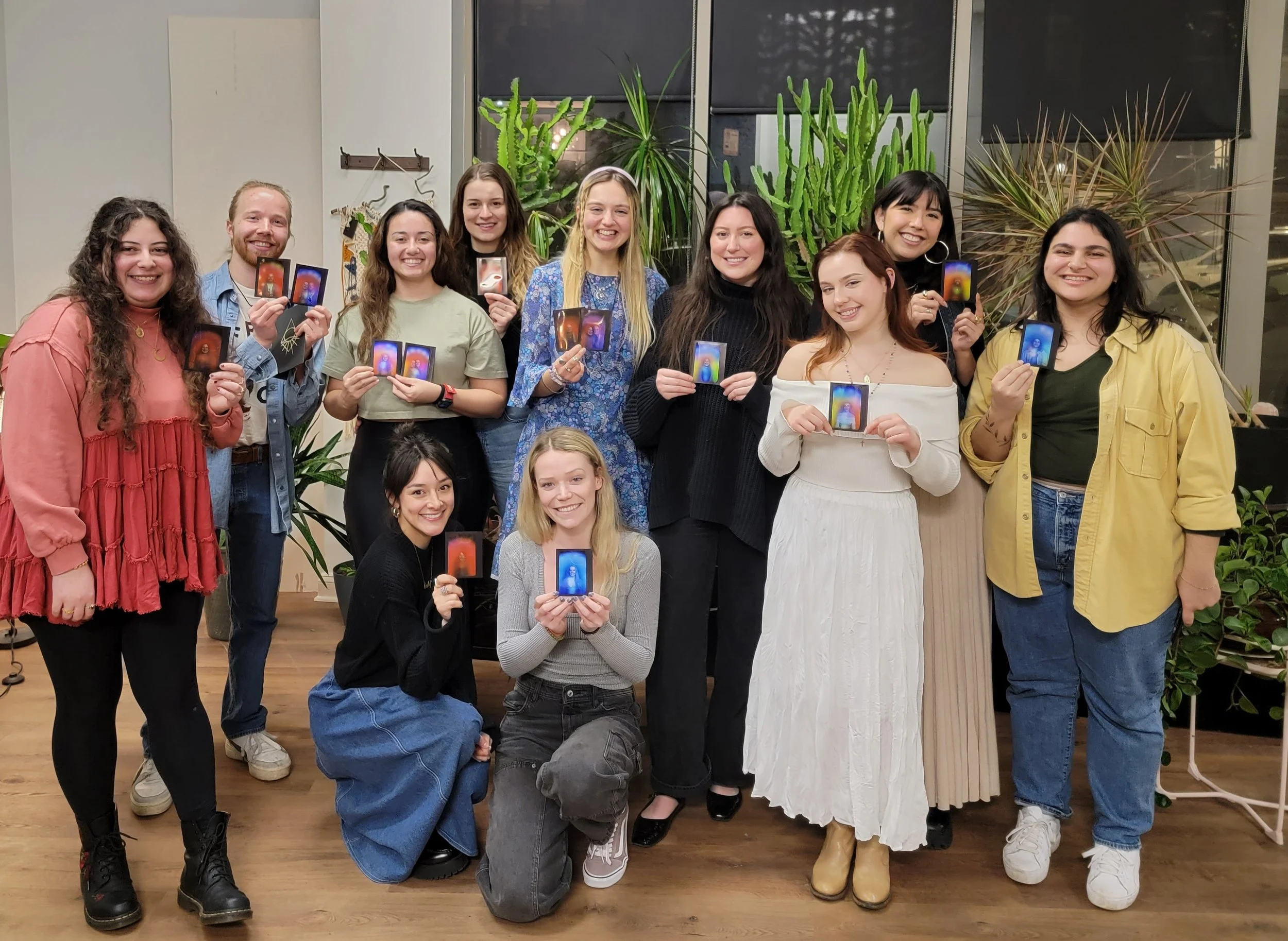 Group of people holding their aura photos in our studio in Chicago.
