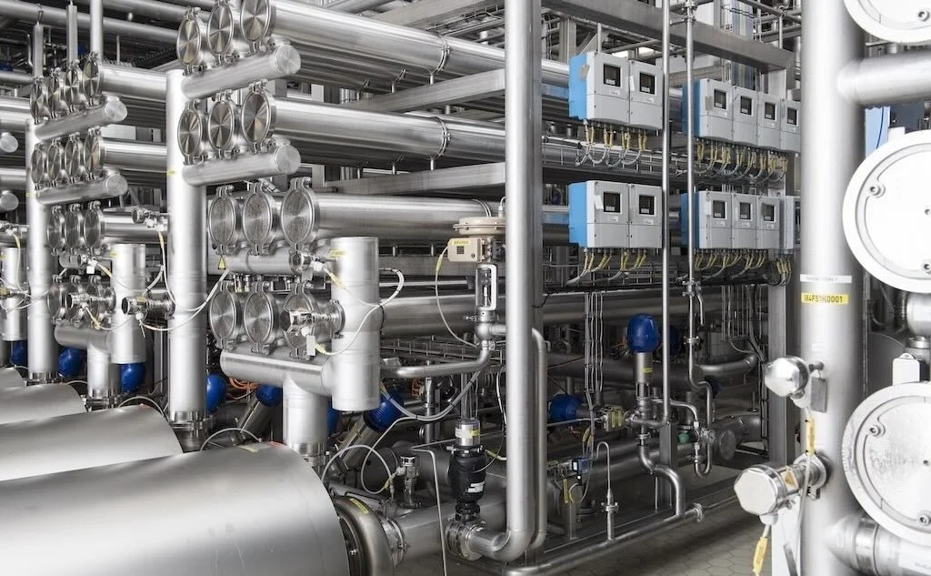 Industrial machinery with pipes and valves in a factory. Process and flow. Instrument, calibration.