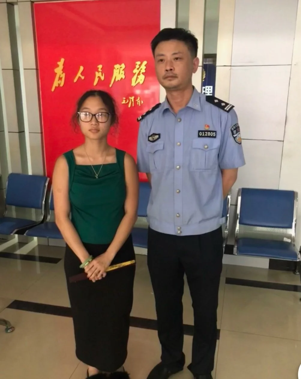 Photo of Lacey with the police officer who found her.