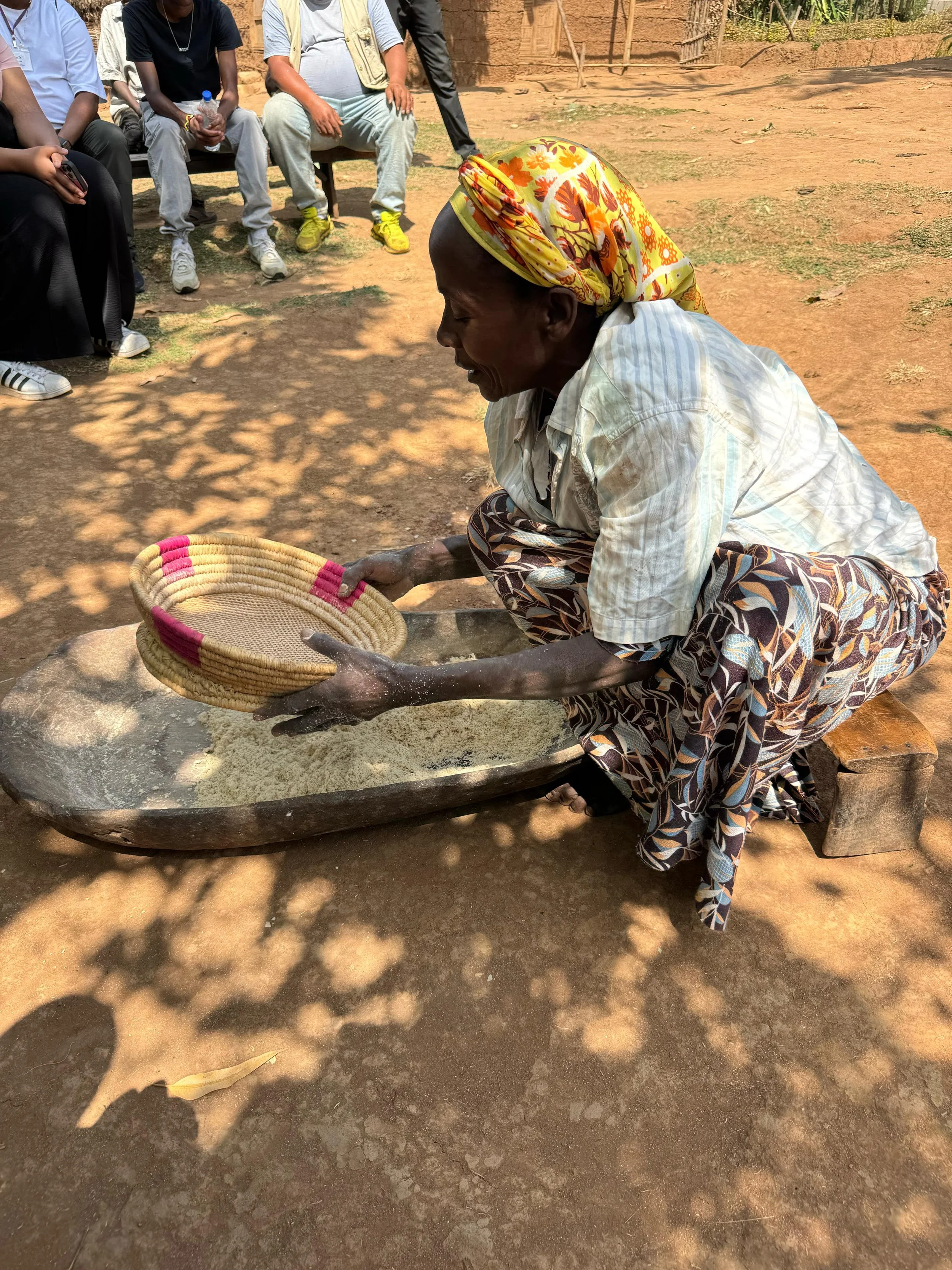 An Ethiopian woman demonstrates a cooking technique.