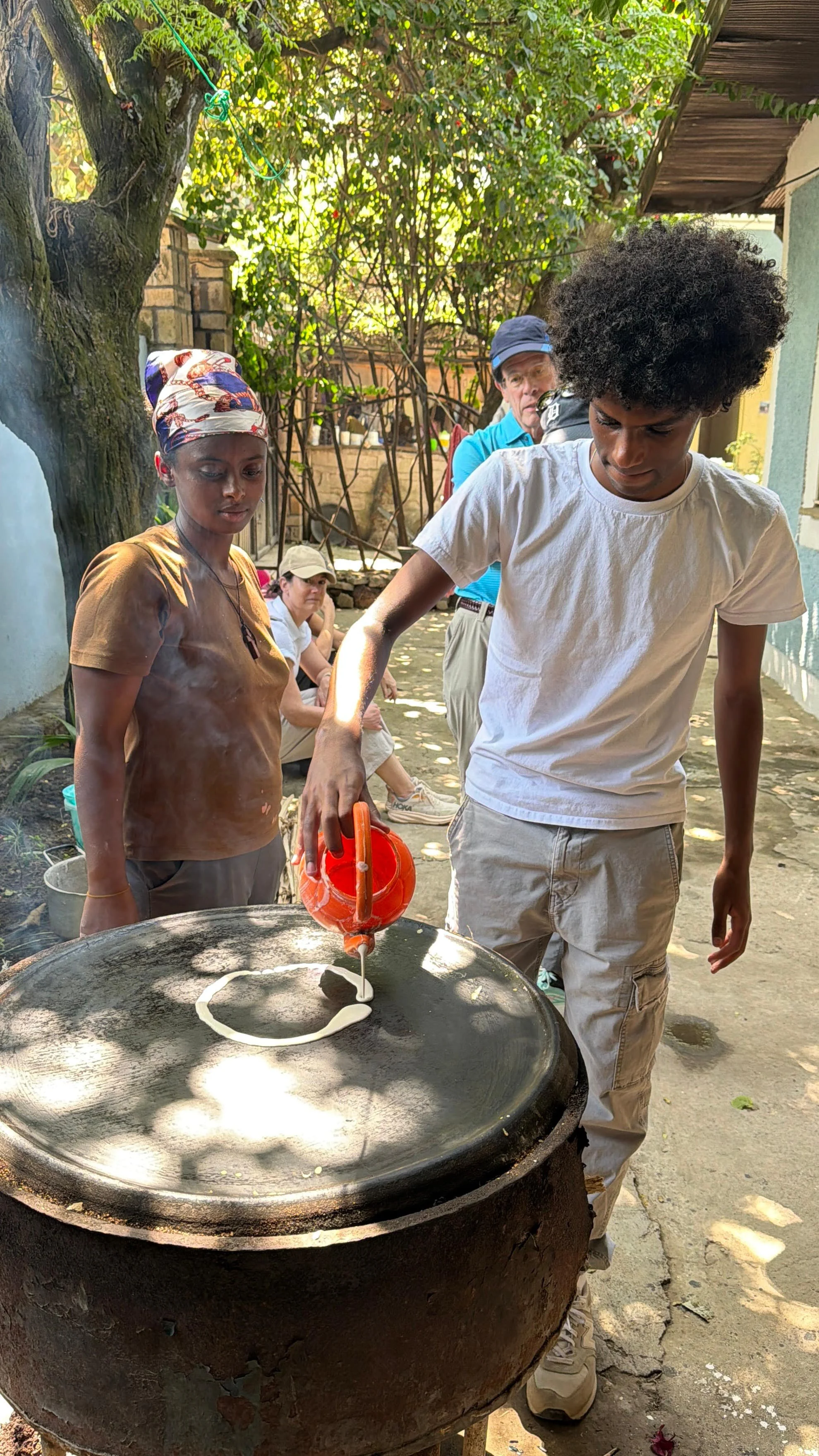 A young man cooks a traditional Ethiopian bread.