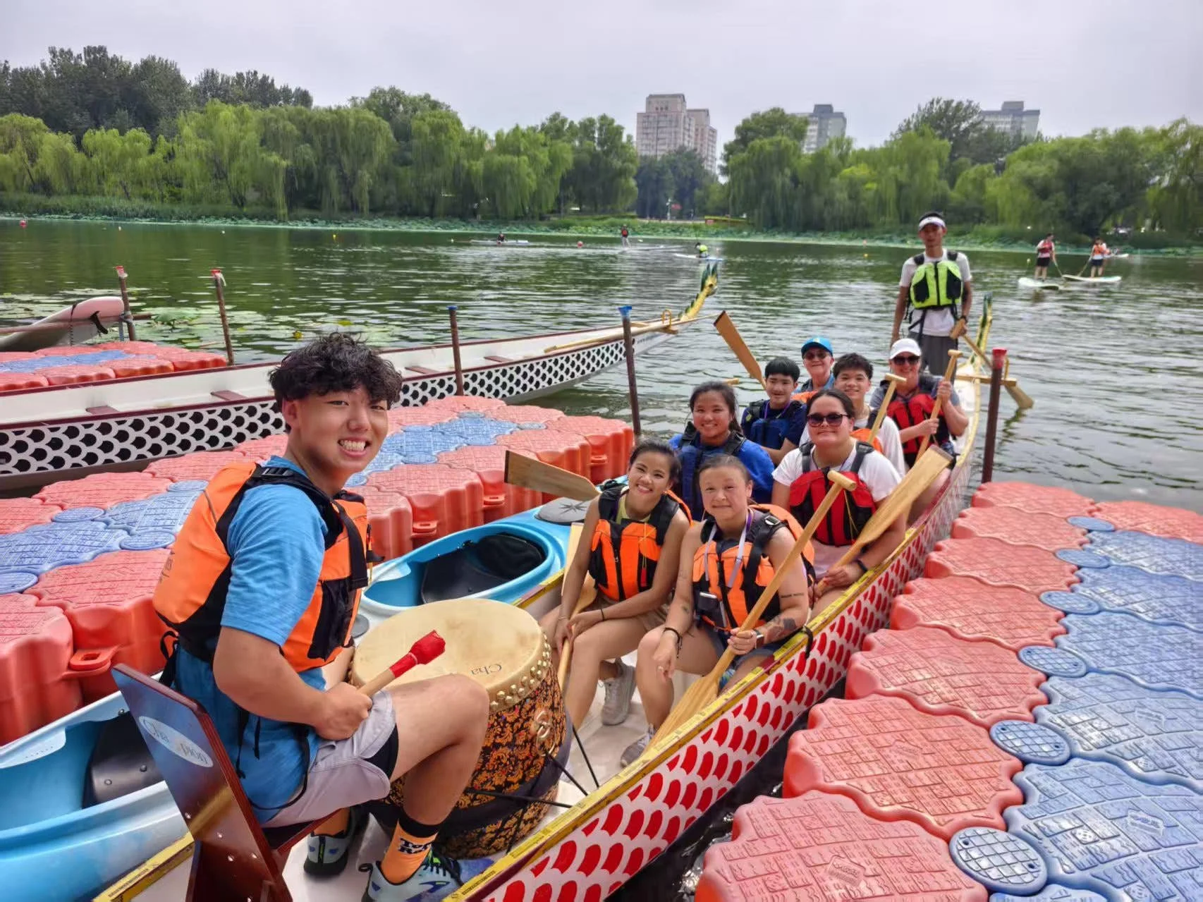 Chinese adoptees and their loved ones pose in a boat.