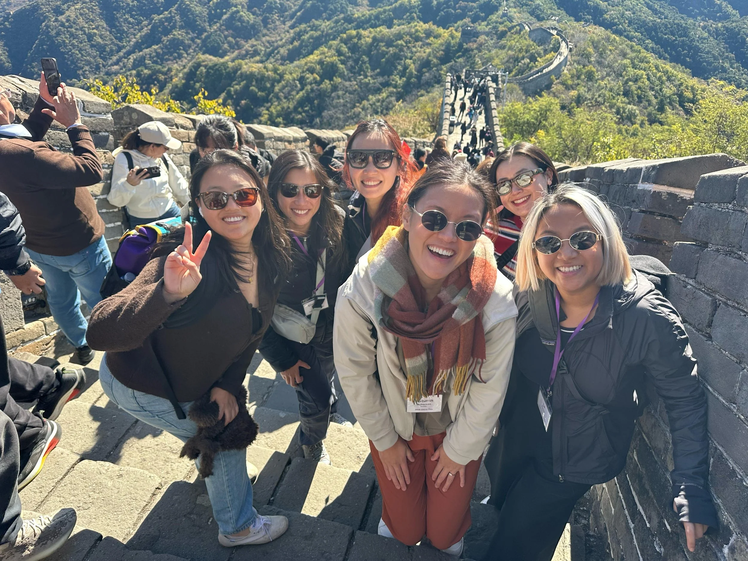 6 woman smile on the steps of the Great Wall of China during China Ties 21+.