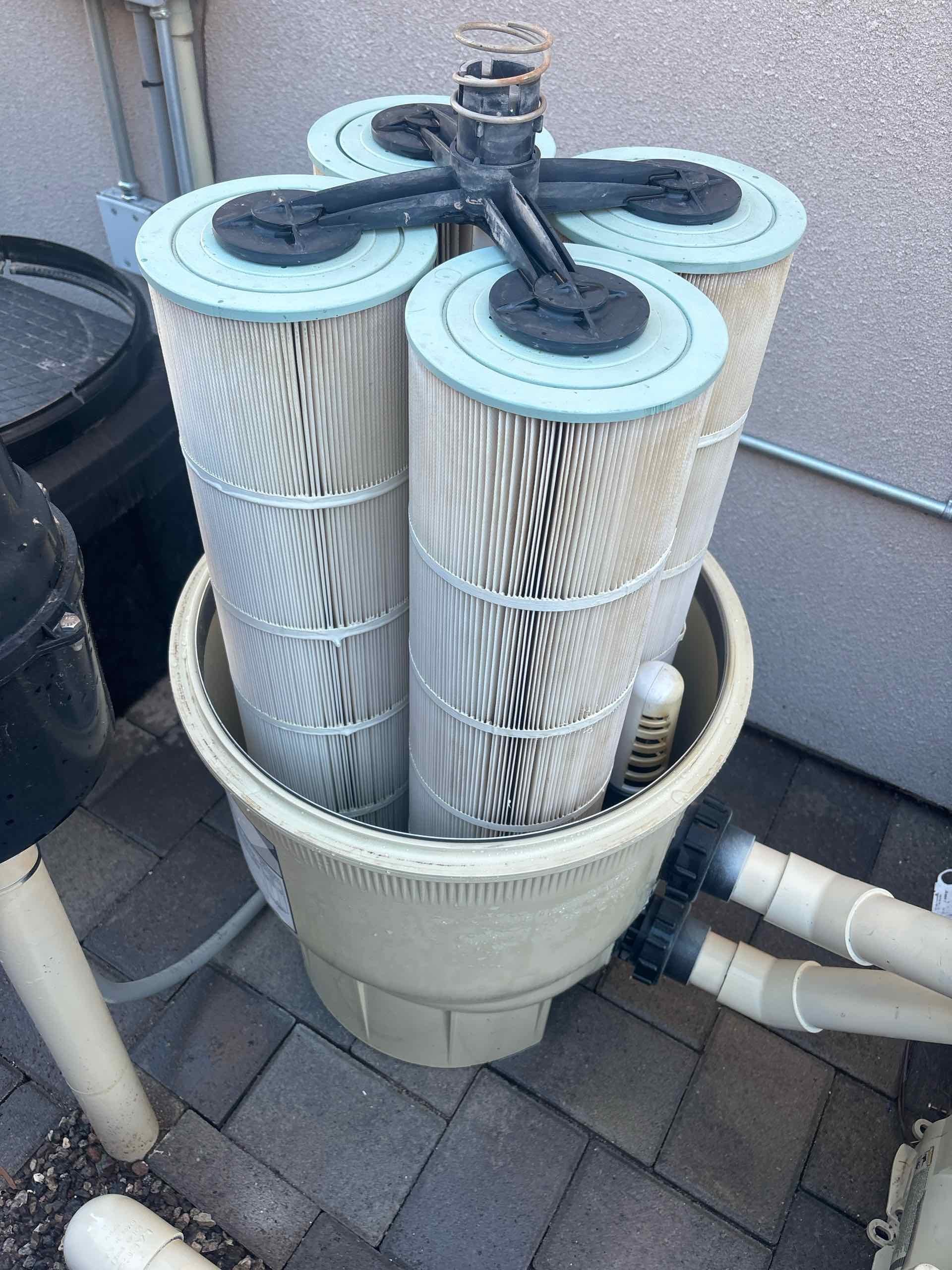 Pool pump and filter system with three clean filter cartridges.