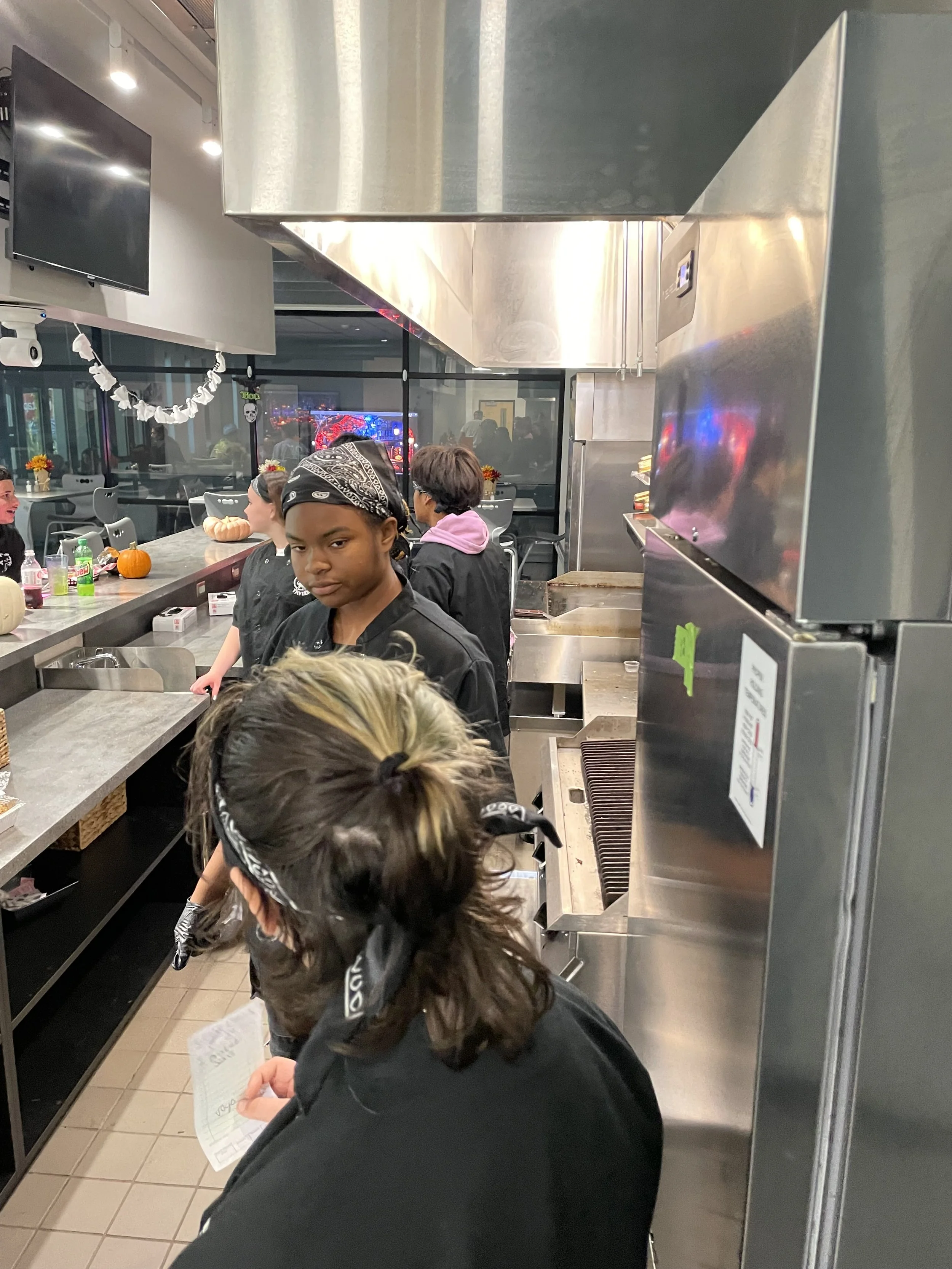 A busy day in the Tavern! Two students converse about the restaurants order tickets. 