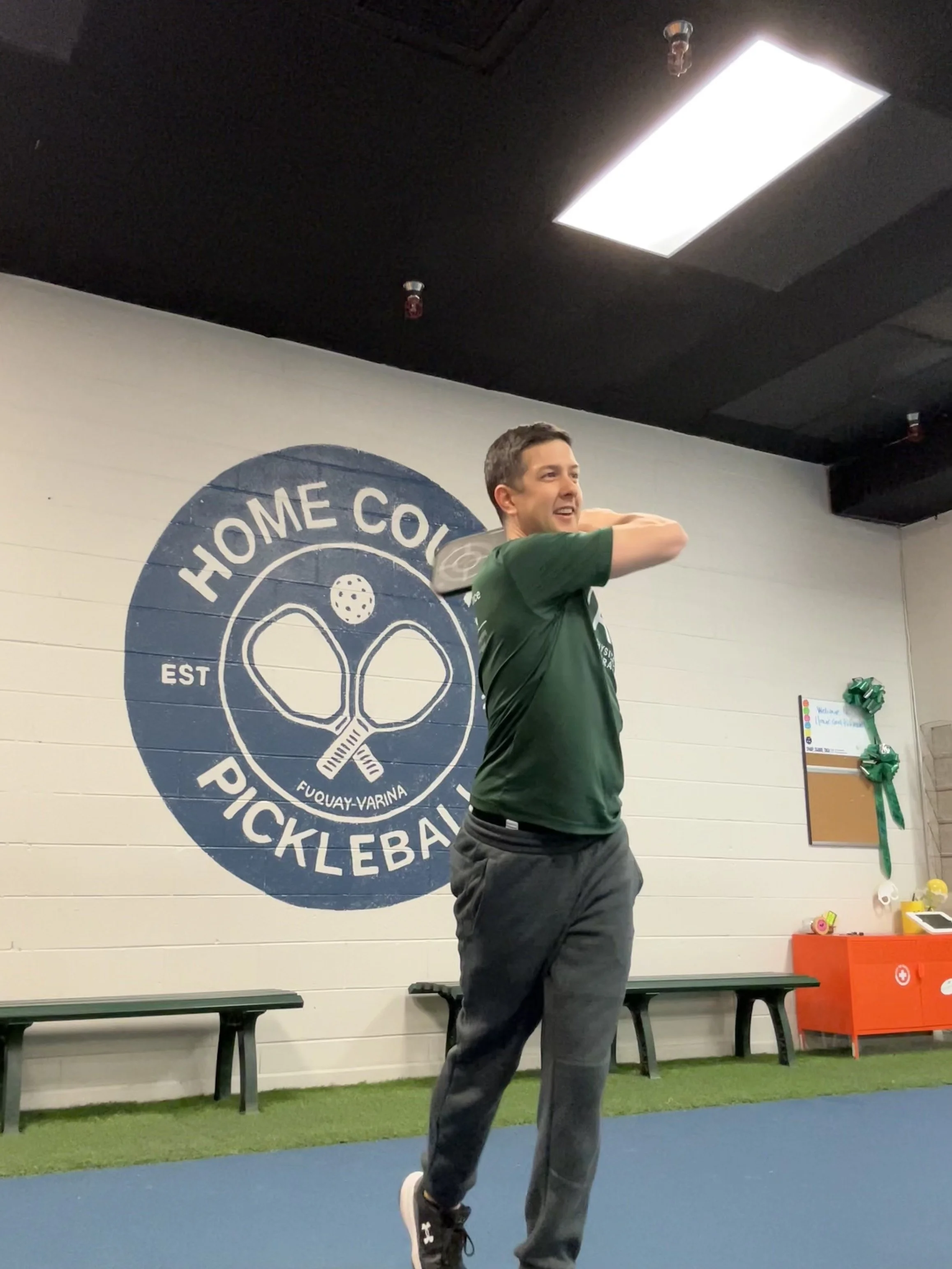 Dr. Ned Bixby hitting a pickleball serve. All Time Performance Physical Therapy serving Fuquay Varina, Holly Springs, Apex, Cary, and Garner