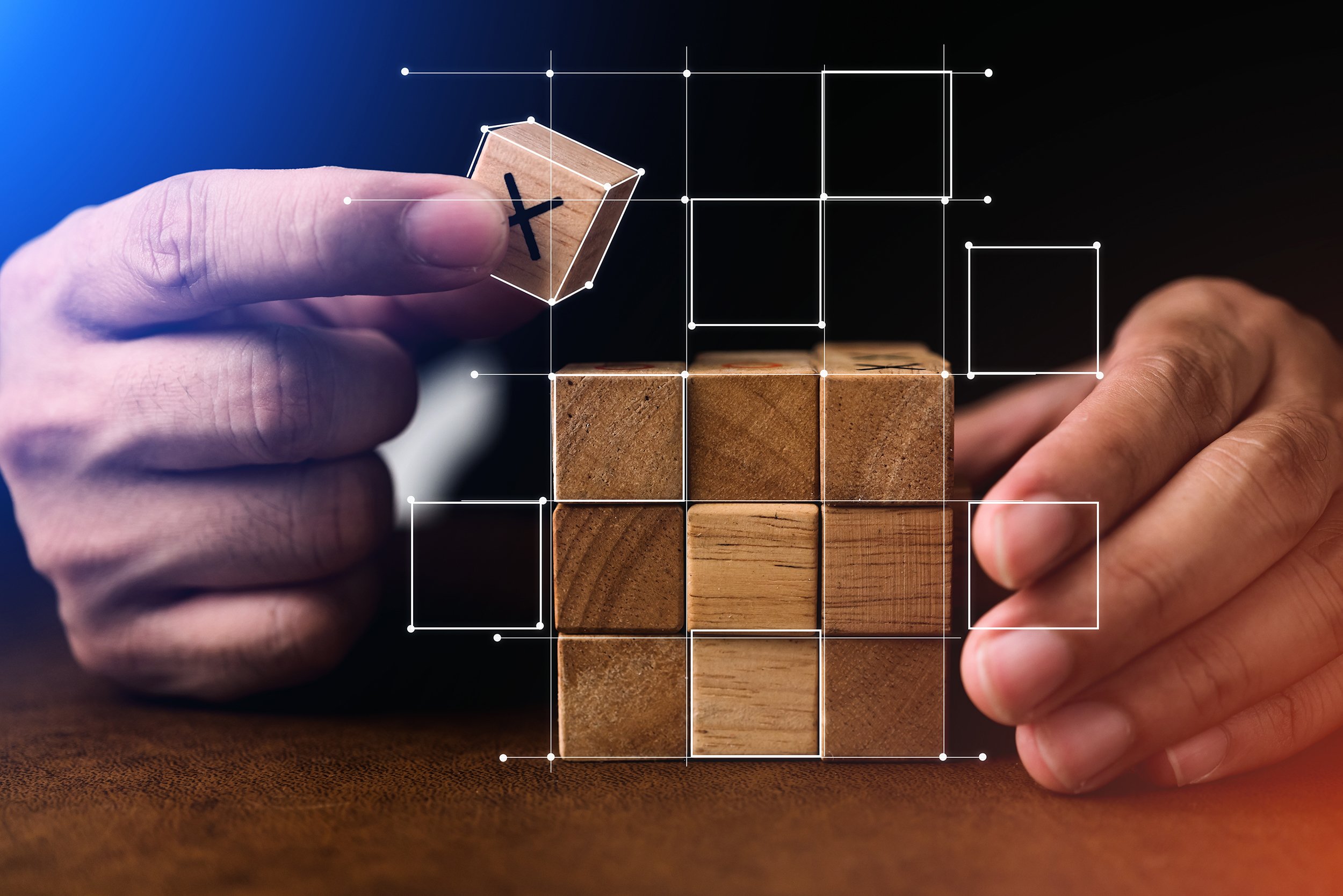 Two hands holding puzzle pieces in front of a backlit group of people, symbolizing teamwork or collaboration.