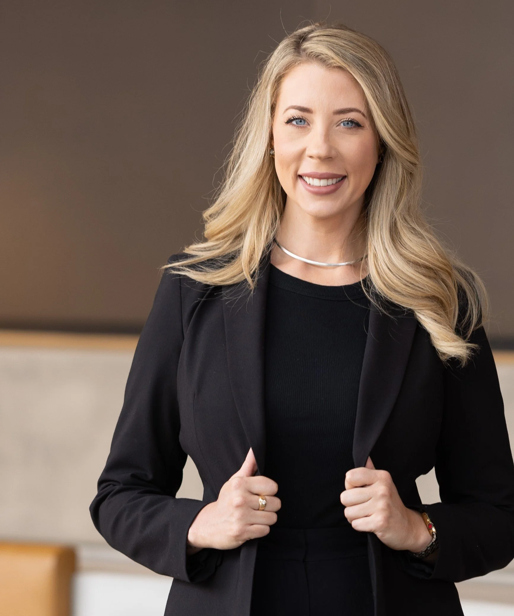 Professional headshot of a smiling blonde woman in a black suit, representing the bookkeeping expert at Market View Services
