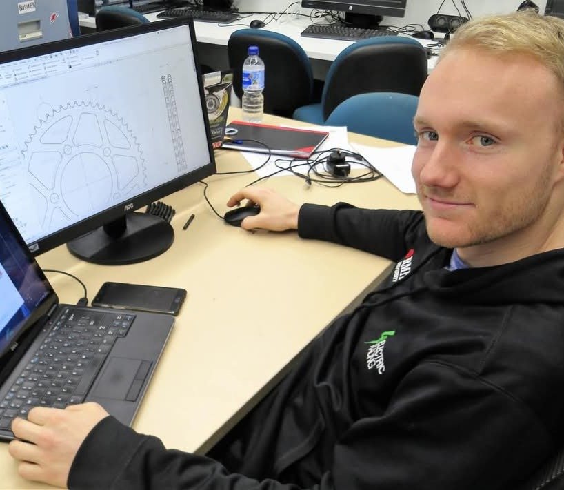 Man using computer with gear design on screen