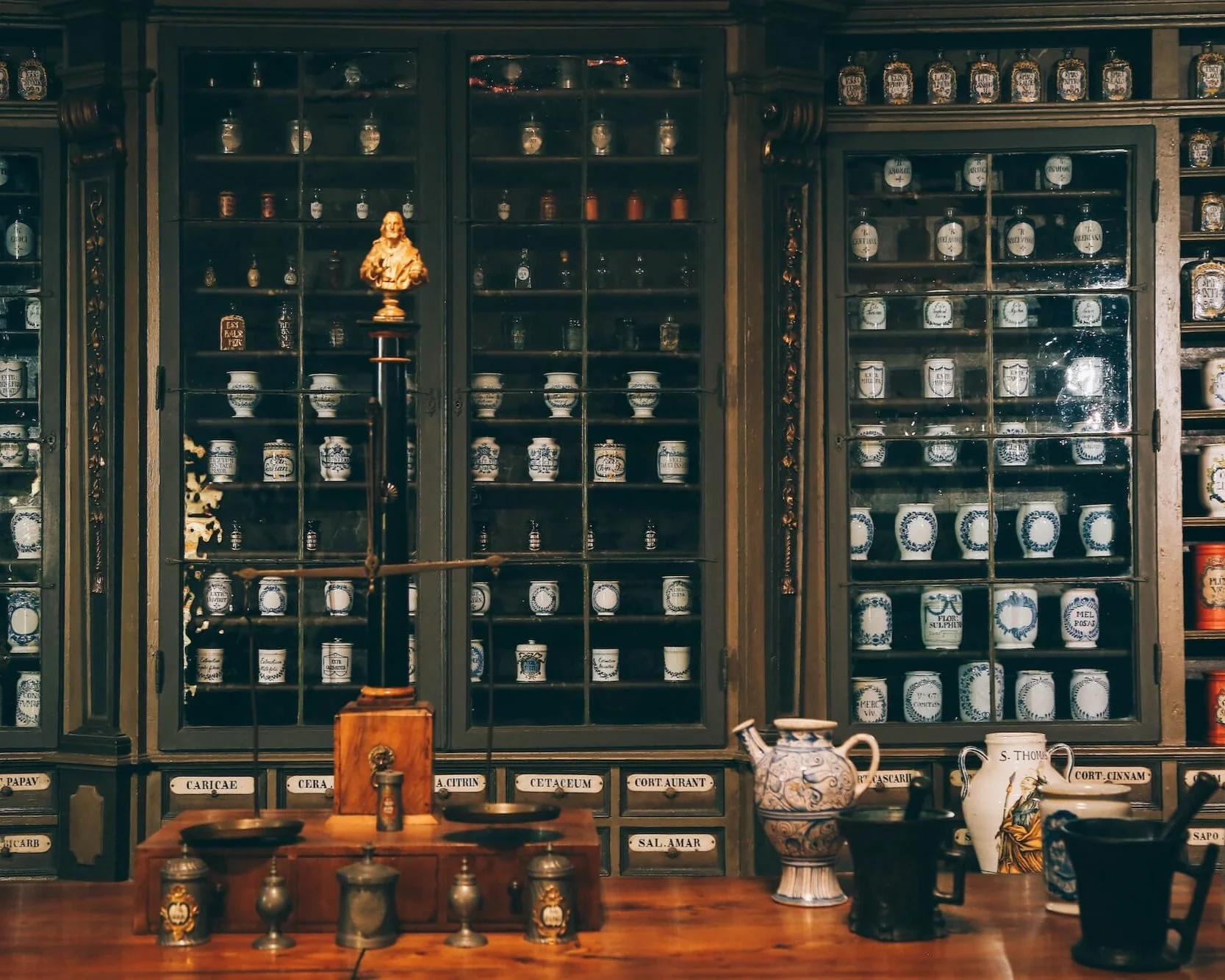 A selection of urns and vases arranged in cabinets for a mythical and historic Greek aesthetic