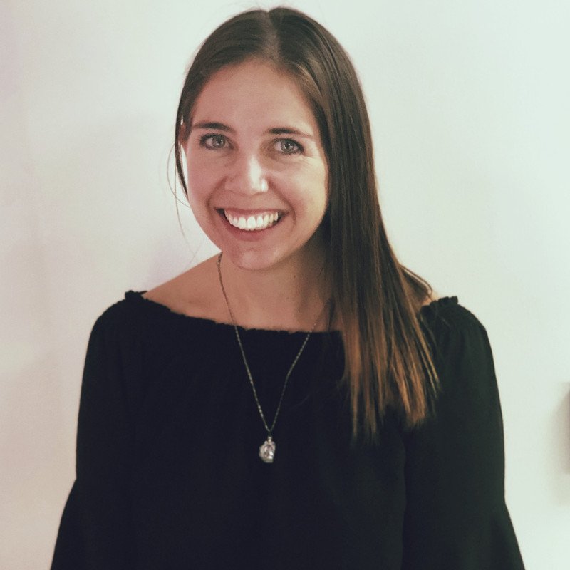 Smiling woman wearing a black shirt and necklace