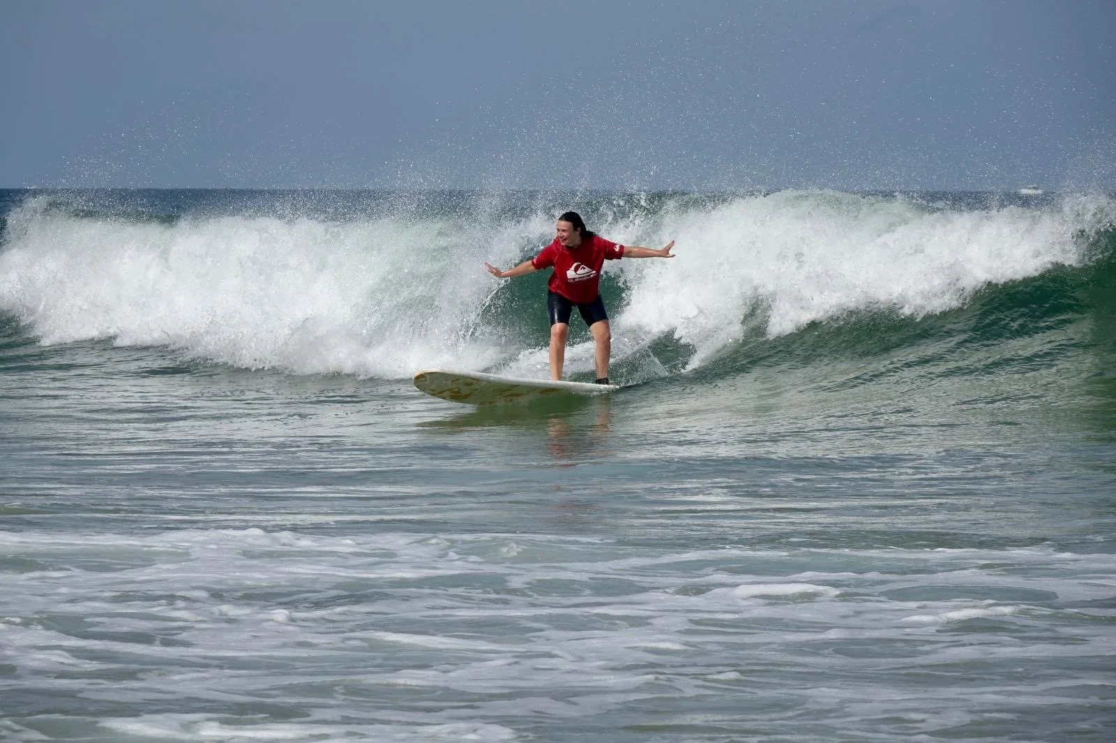 A person surfing on a wave in the ocean.