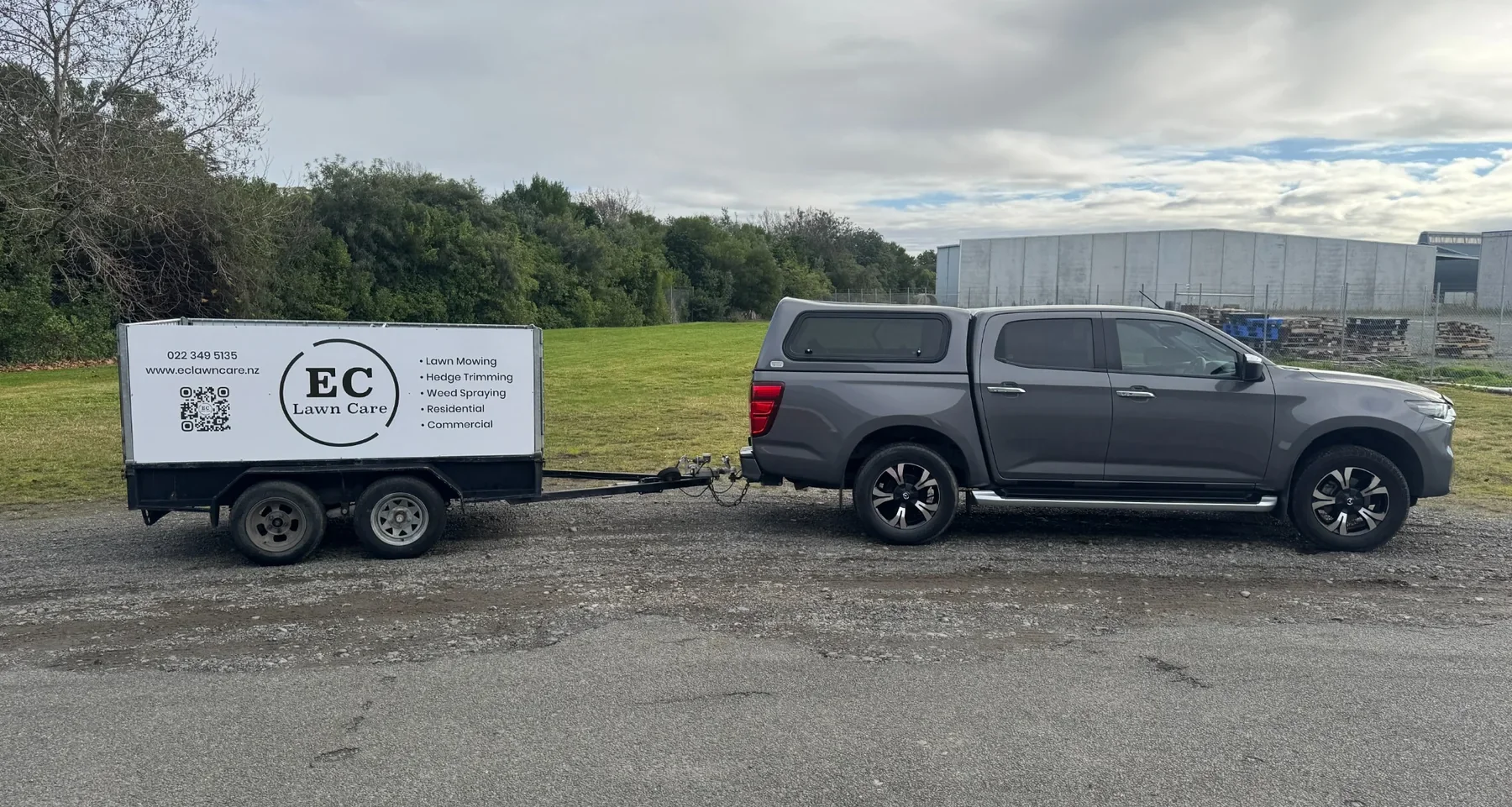 EC Lawn Care branded trailer and Mazda BT-50 at a commercial grounds maintenance site in Hawke's Bay.