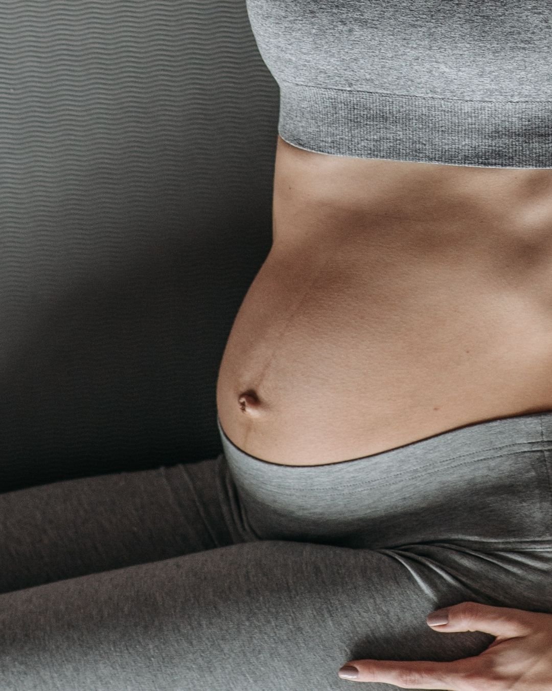 Pregnant woman's torso on a pilates mat
