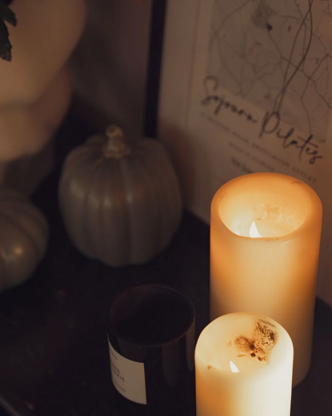 Warm candlelight inside Sojourn Pilates studio, Broughton Astley. The softly lit atmosphere mirrors the calming, parasympathetic feel of an infrared Pilates class.