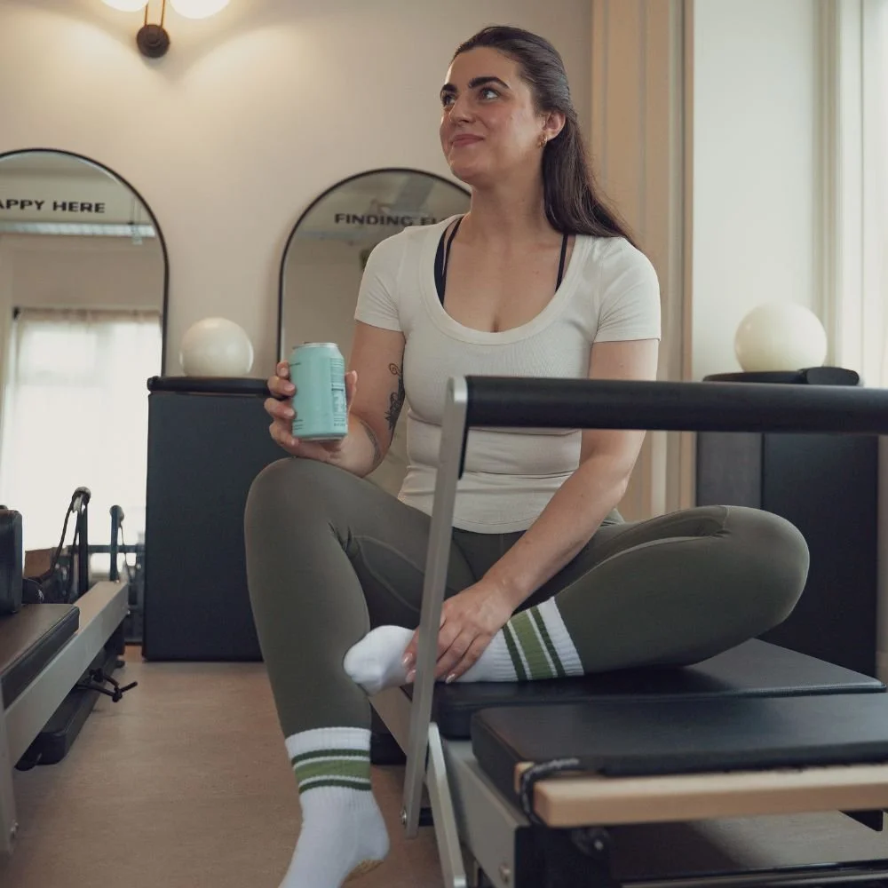 Charlotte Hayto, founder of Sojourn Pilates, in the Broughton Astley studio with the infrared affirmation mirrors behind her.