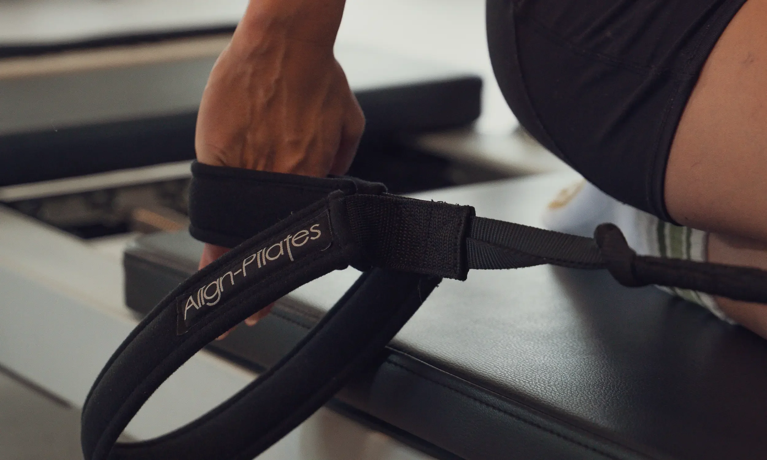 Close-up of an Align-Pilates reformer strap in use during a class at Sojourn Pilates, a boutique reformer studio in Broughton Astley, Leicestershire.