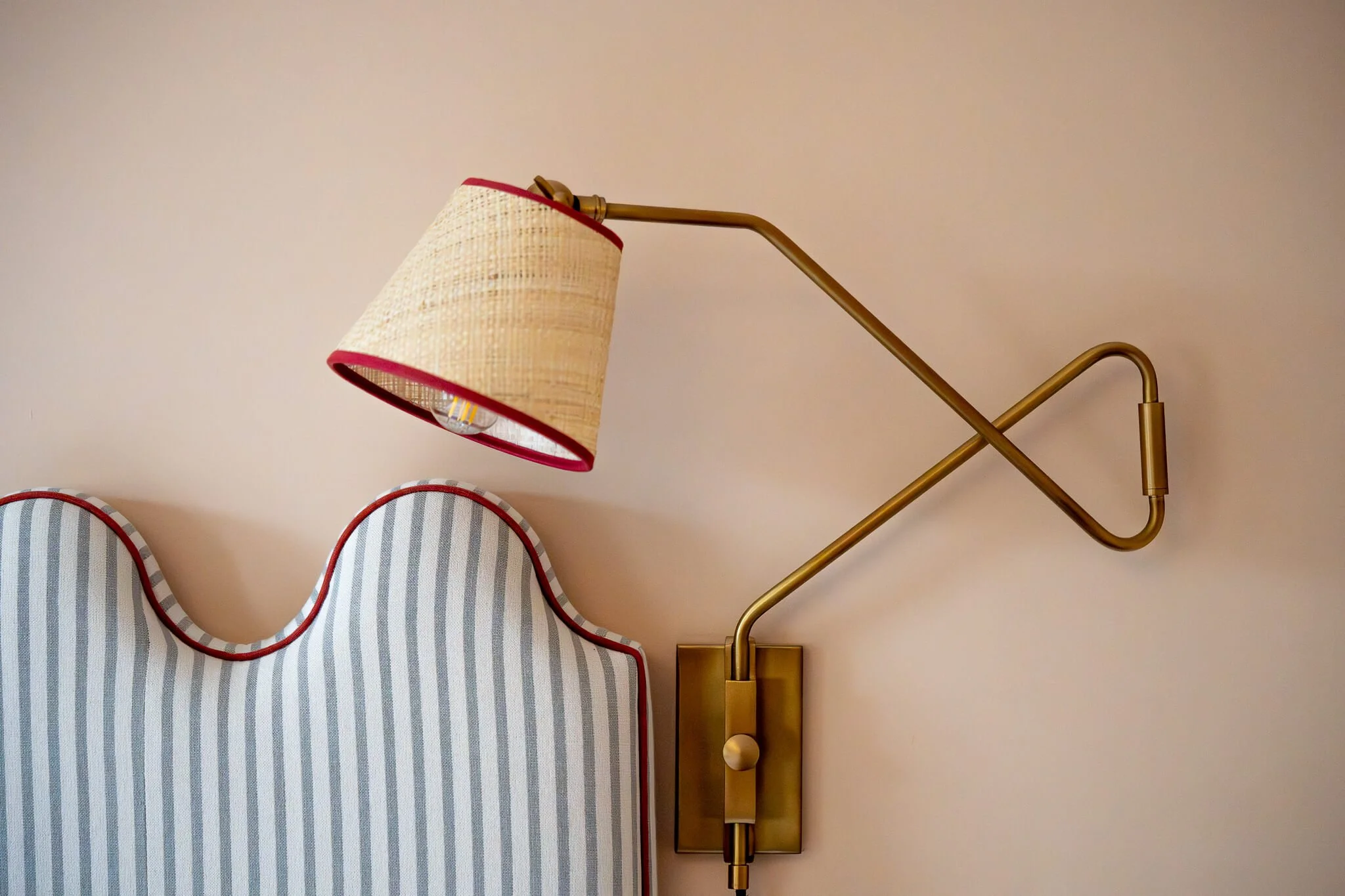Coastal bedroom styling, headboard and matching reading light in luxury Norfolk holiday home