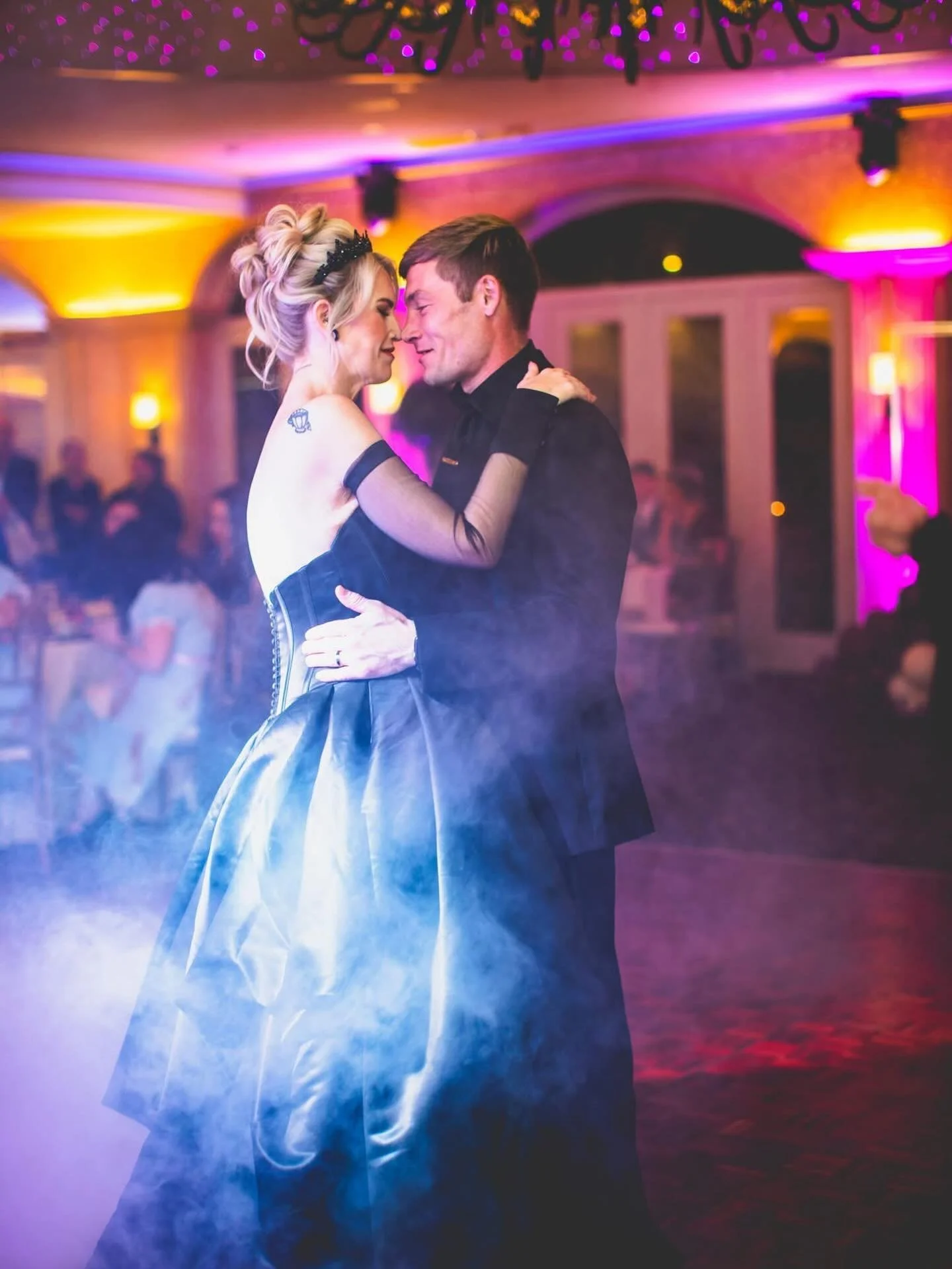 I never posted this?? Oops! 🤭

Baby&rsquo;s first fog machine first dance photo! I love the colors of the ballroom and how it all played so nicely with the spooky wedding vibes. 😍