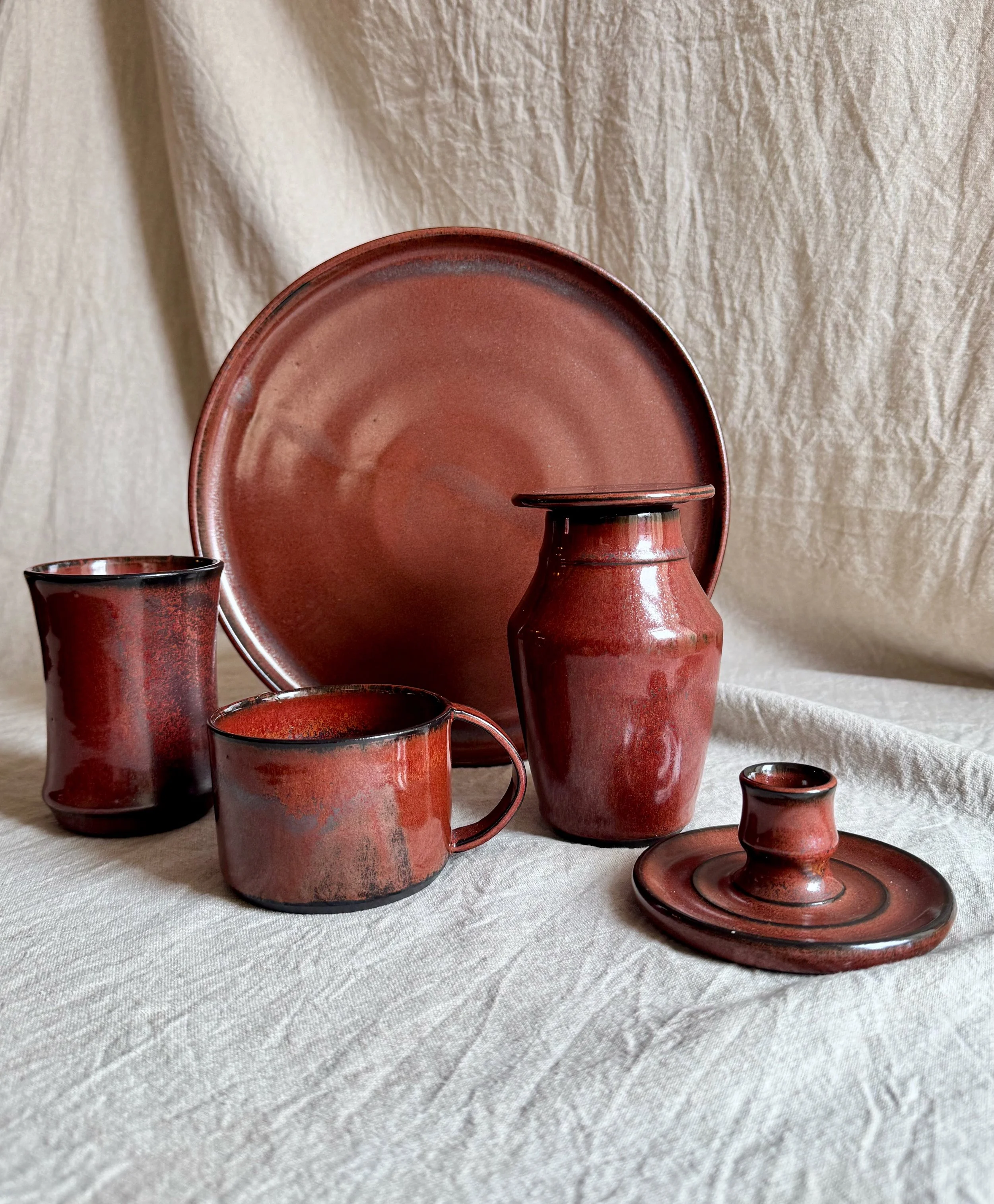 Handmade ceramic objects in rust red