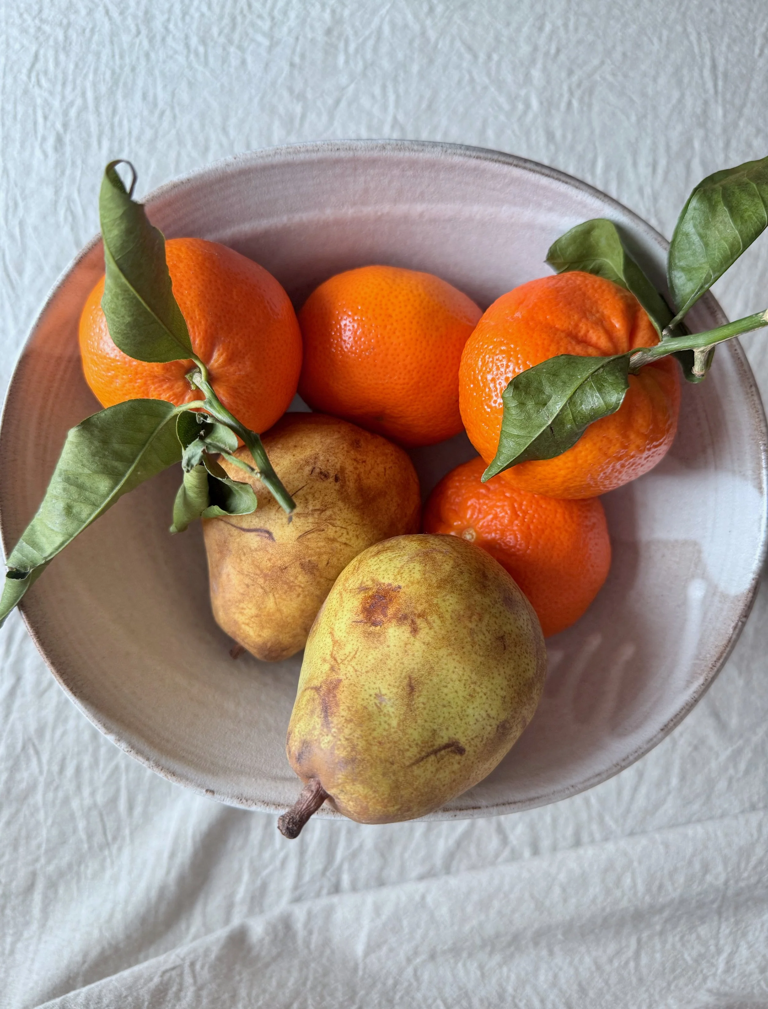 top view of handmade ceramic pedestal bowl with fruit