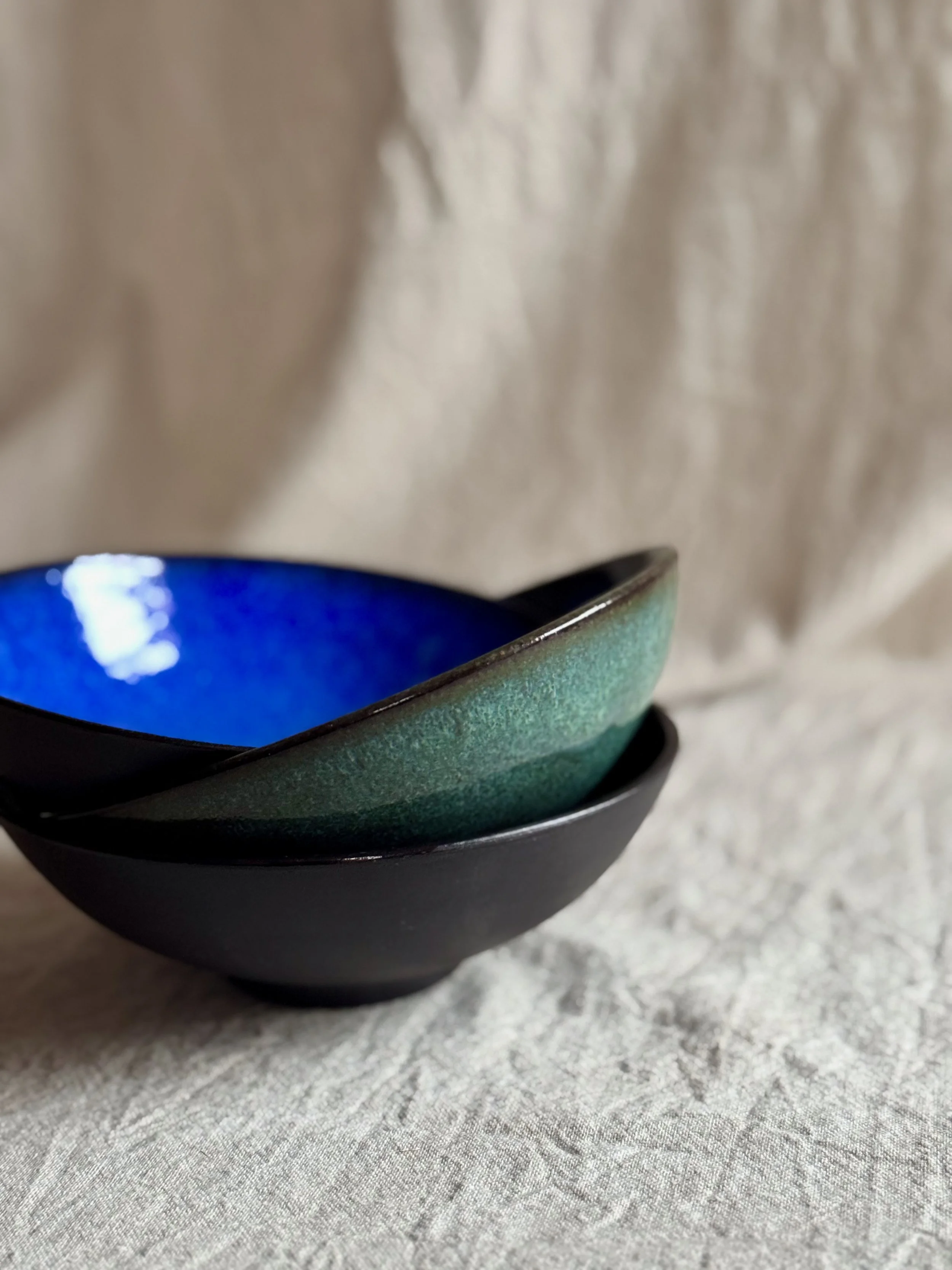 Three stacked handmade ceramic bowls