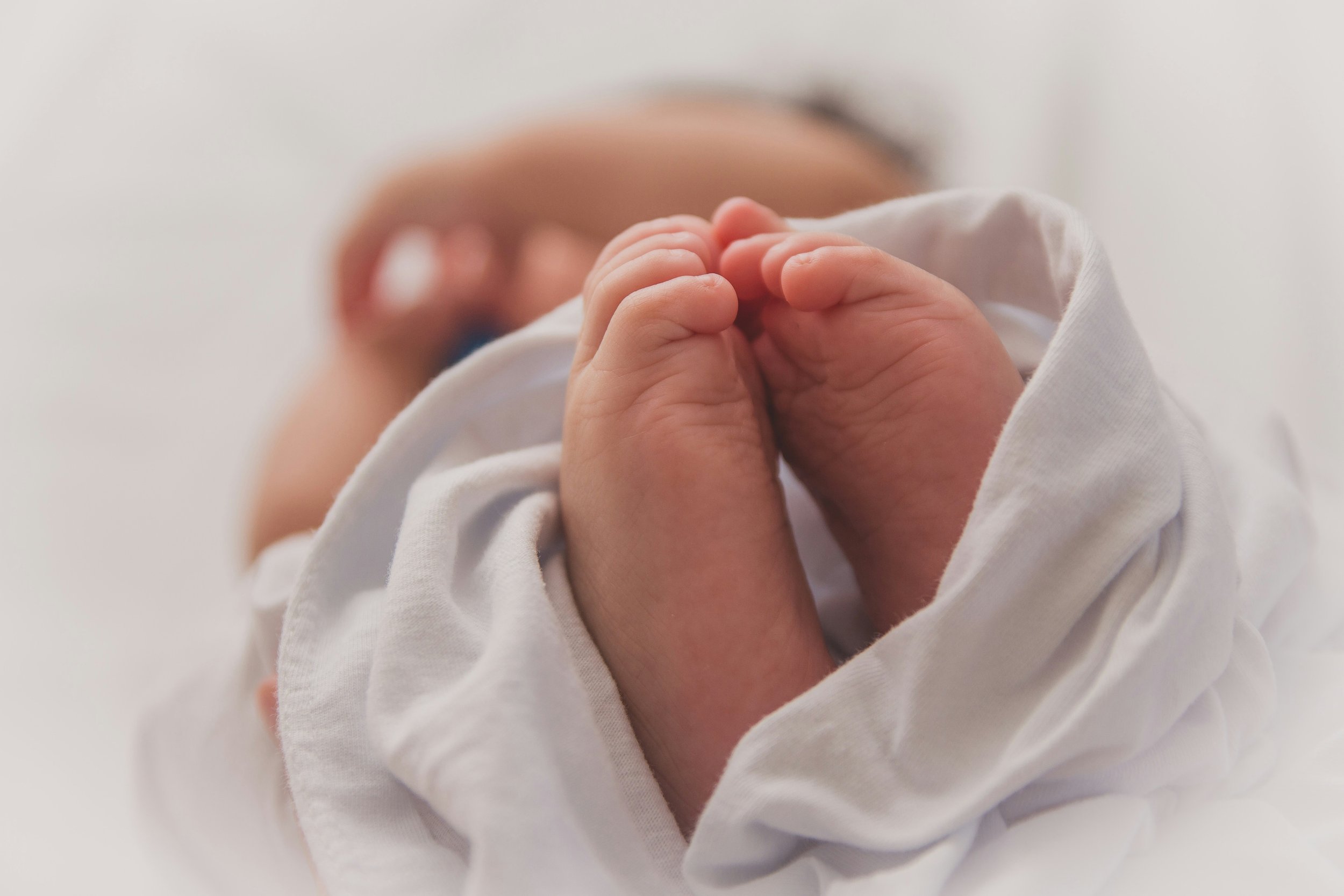 sleeping newborn baby focused on baby feet