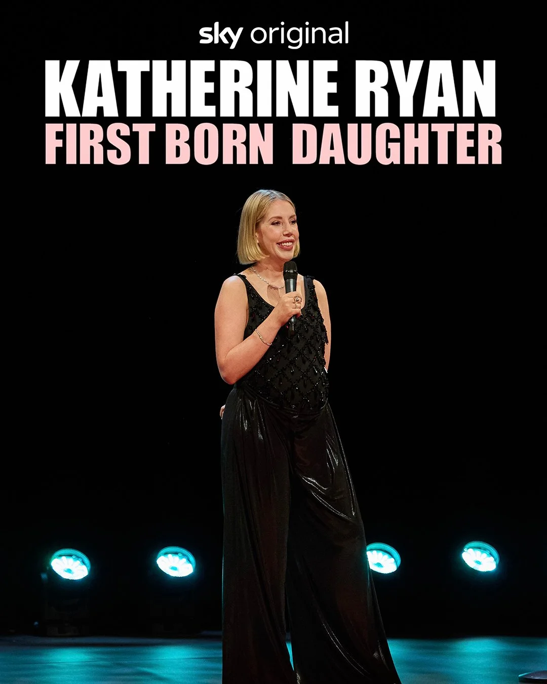 Promotional poster for a TV show titled 'Katherine Ryan: First Born Daughter' with Katherine Ryan in a black dress holding a microphone on stage.