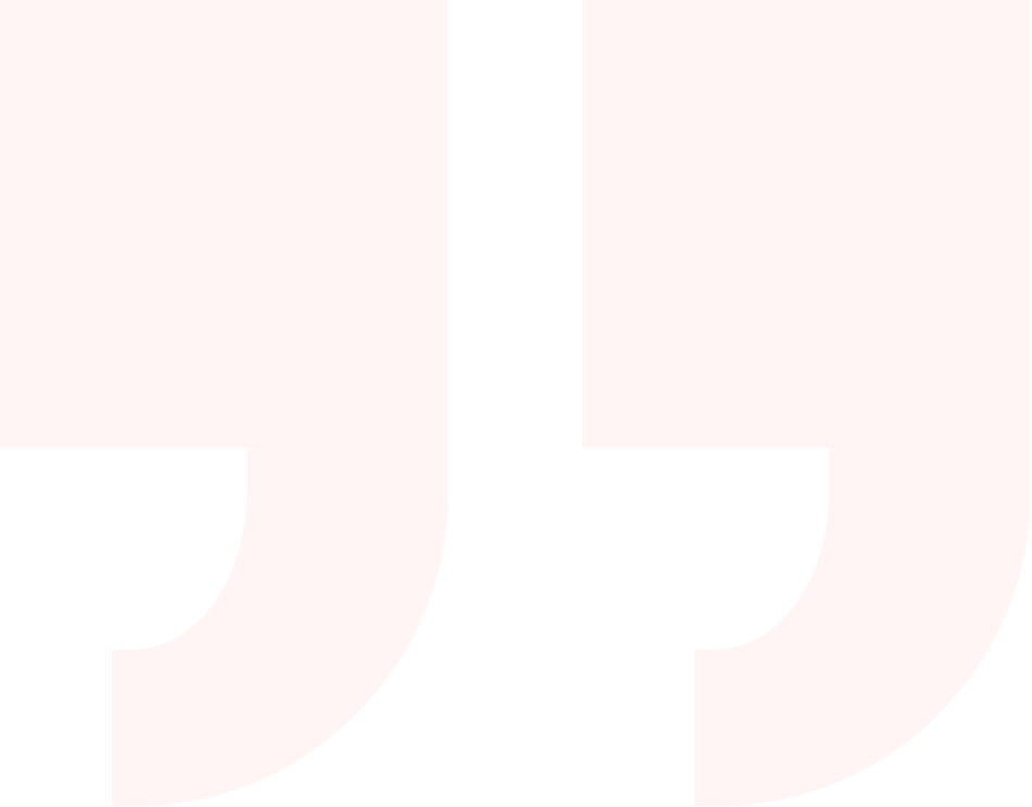 Close-up of a large quotation mark on a pale pink background.