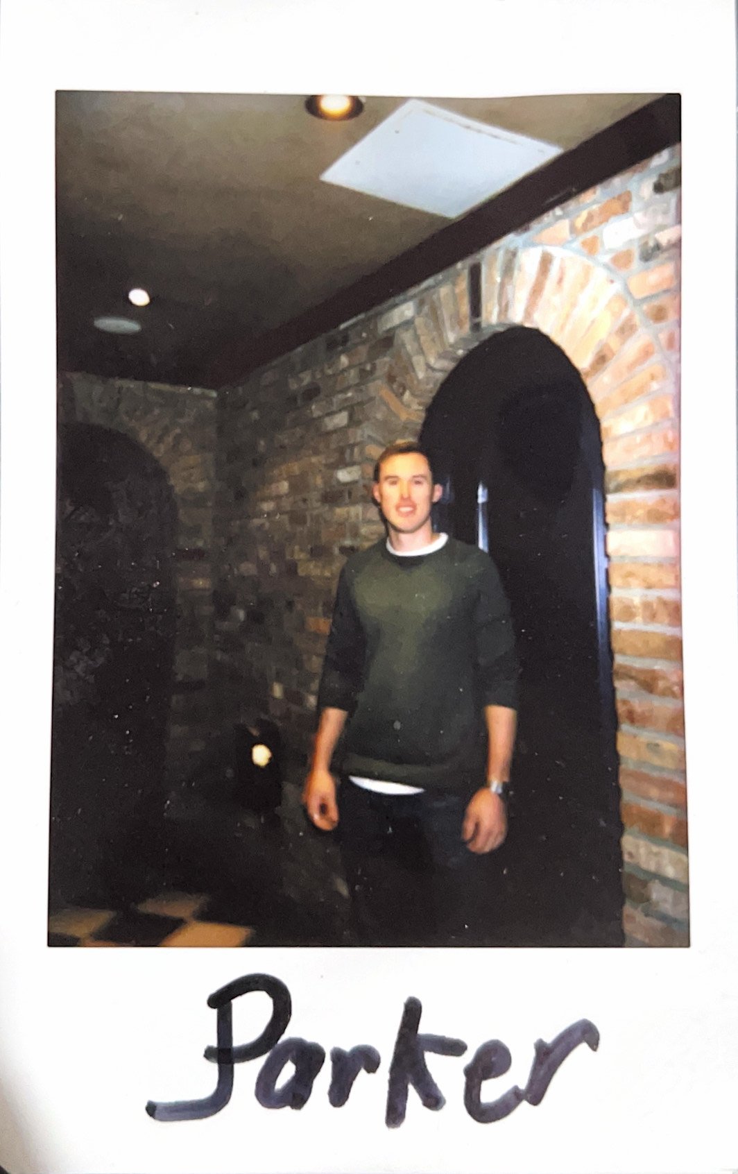 Person standing in front of a brick wall