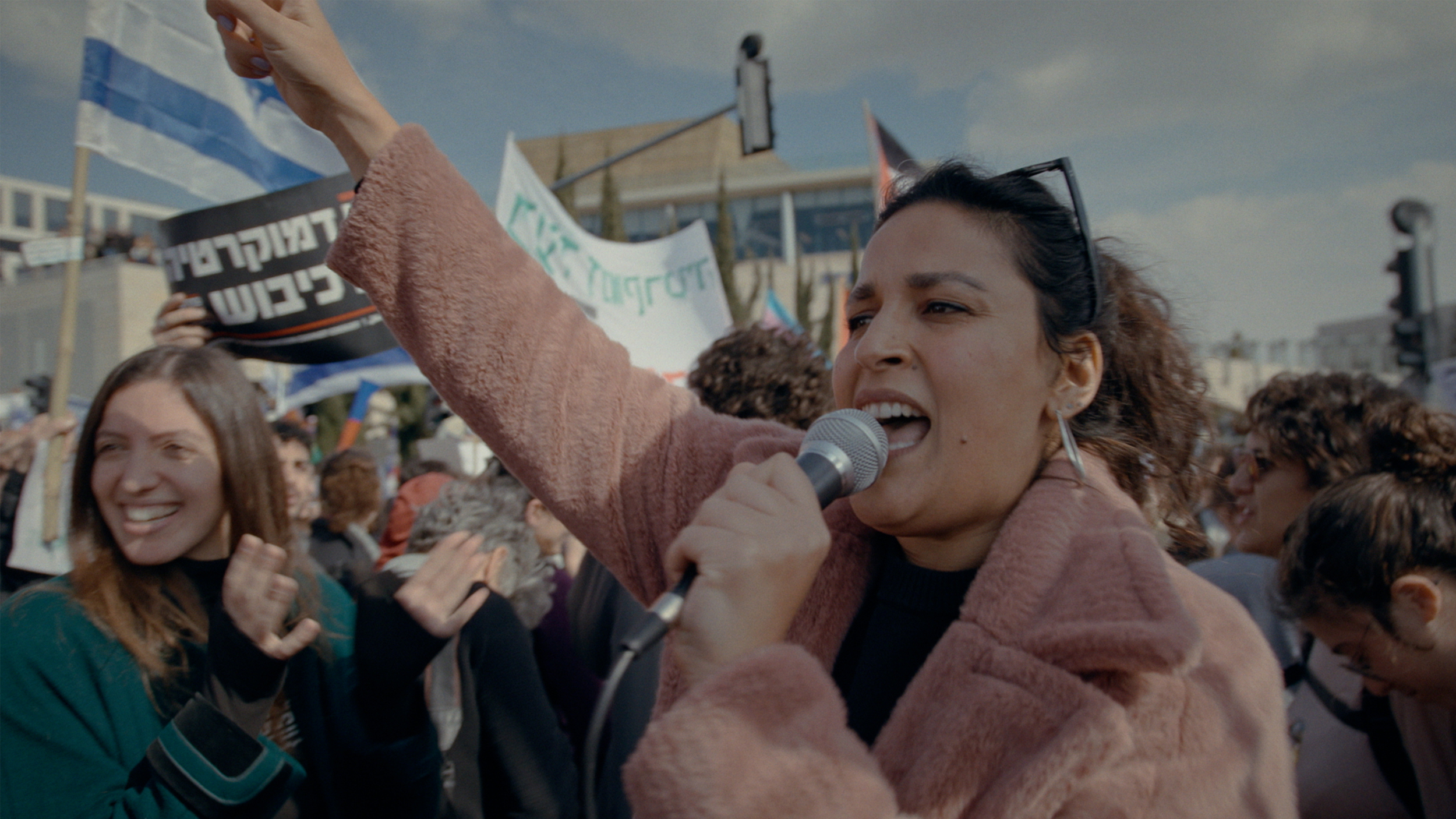  Noam Shuster Elisassi yelling into a megaphone at a protest - credit Philippe Bellaishe Coexistence My Ass