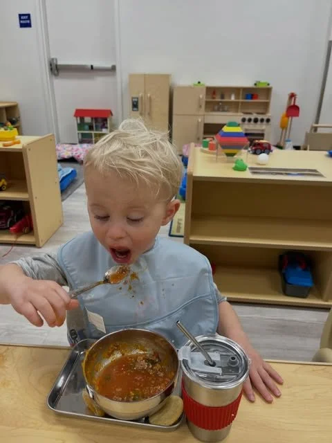 A toddler enjoying lunch
