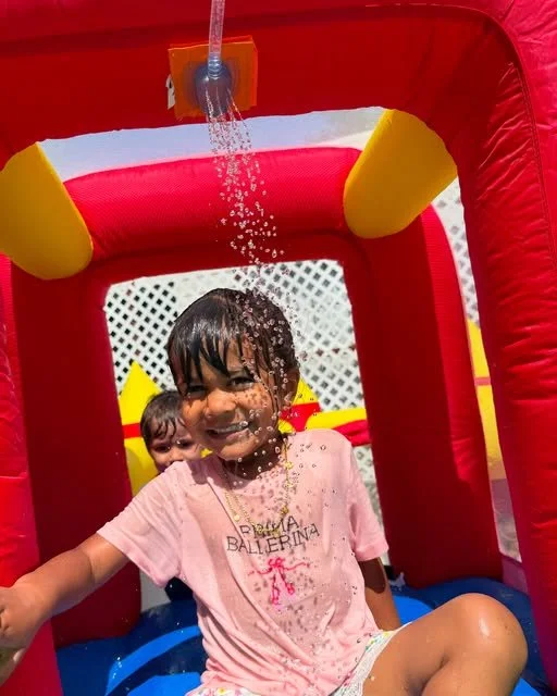 A child splashing in summer water play