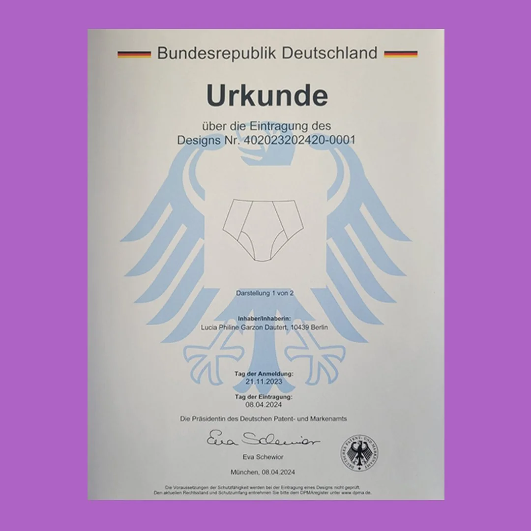 Amtliches Dokument mit deutschem Bundesadler, das eine Urkunde über die Registrierung eines Designs zeigt, mit Unterschrift und Datum.