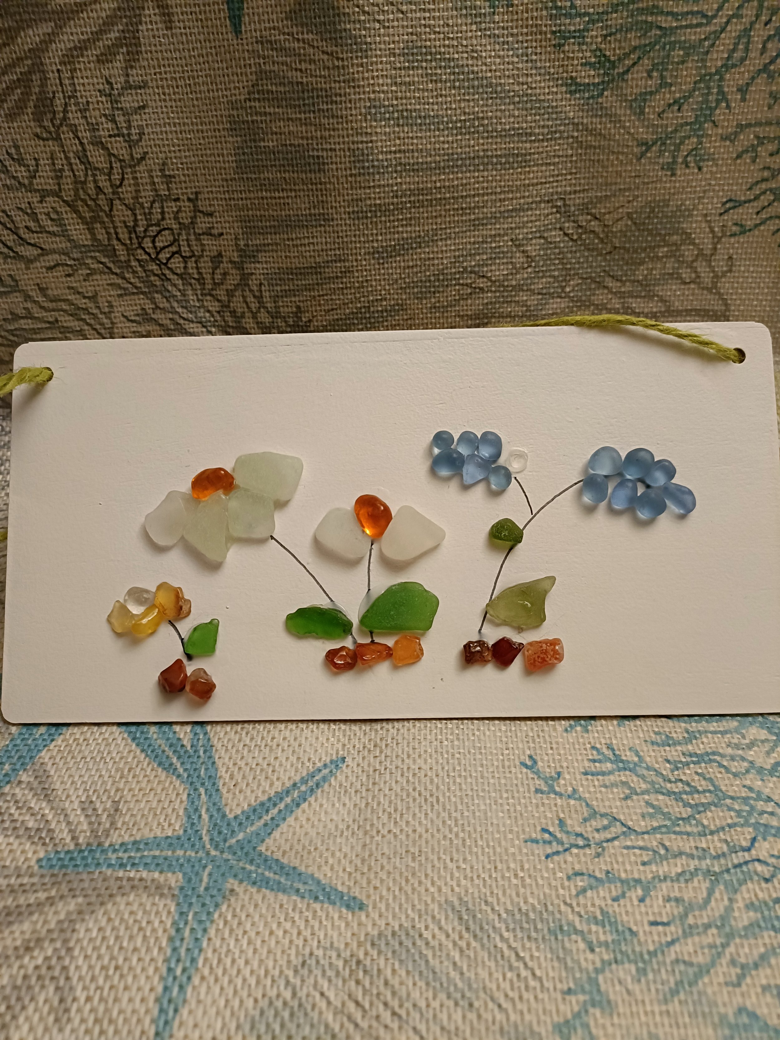Sea glass art on card with floral design