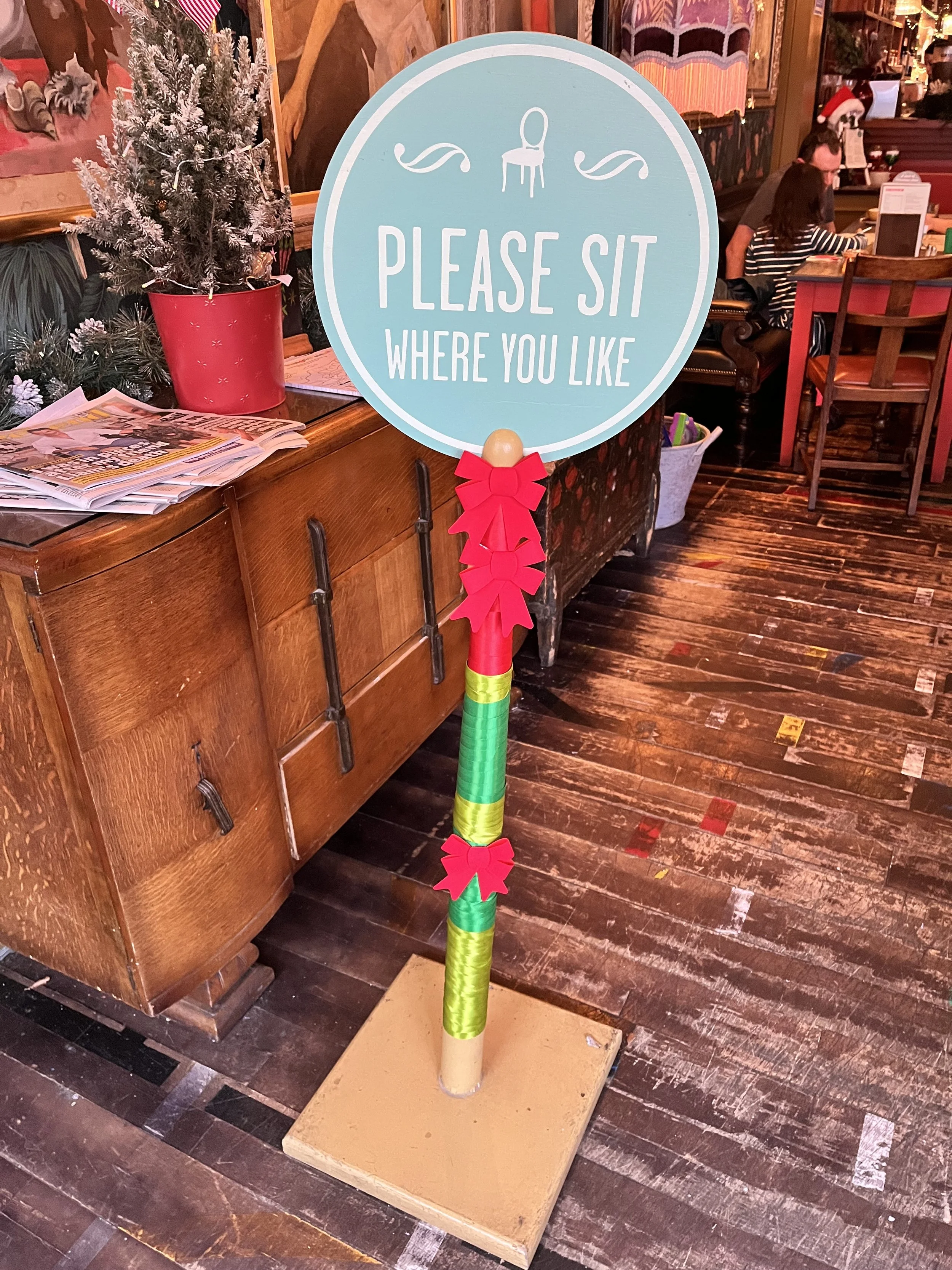 Bows + Ribbons Wrapped Around the Welcome Sign as Part of the Christmas Decorations (2025)