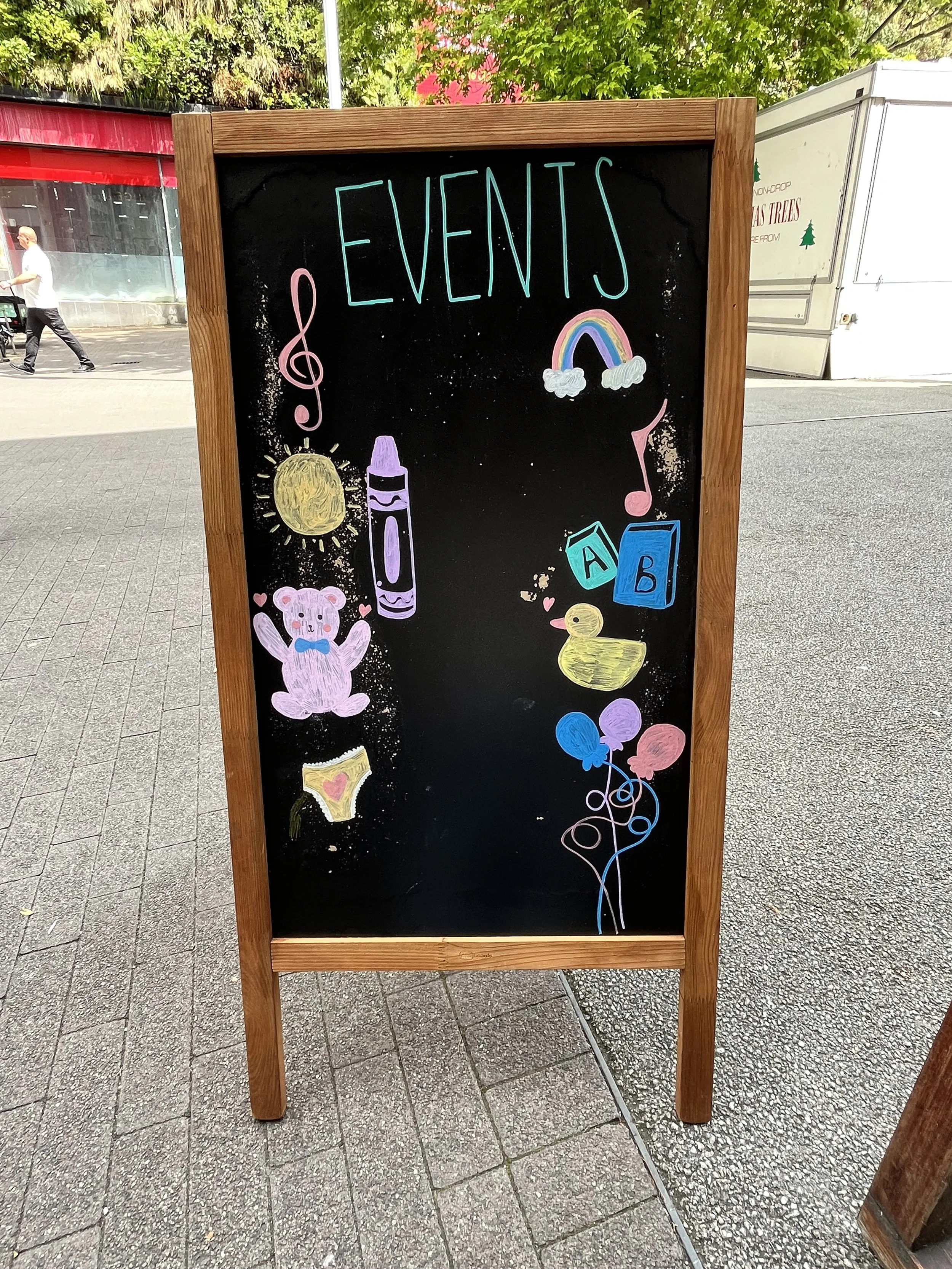 A board pavement sign promoting 'Events'. Hand Drawn text + image using Posca Markers (2025).