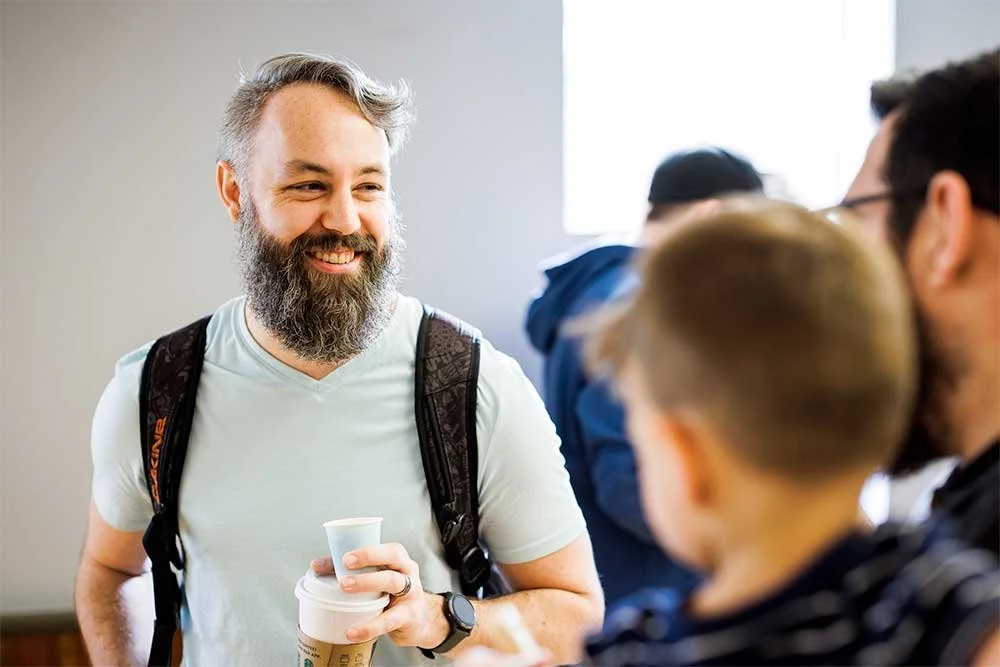Smiling bearded man in crowd