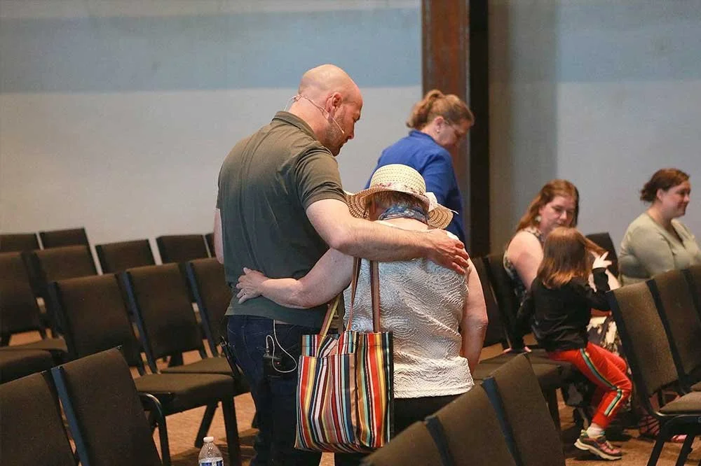 Man praying with a woman