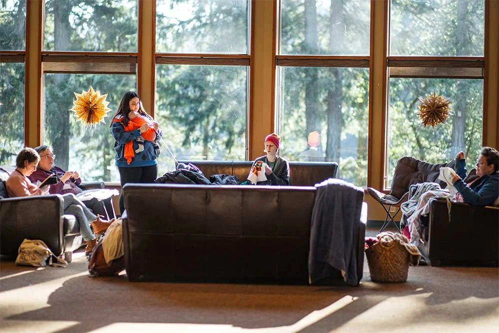 Group of women sitting and knitting on couches