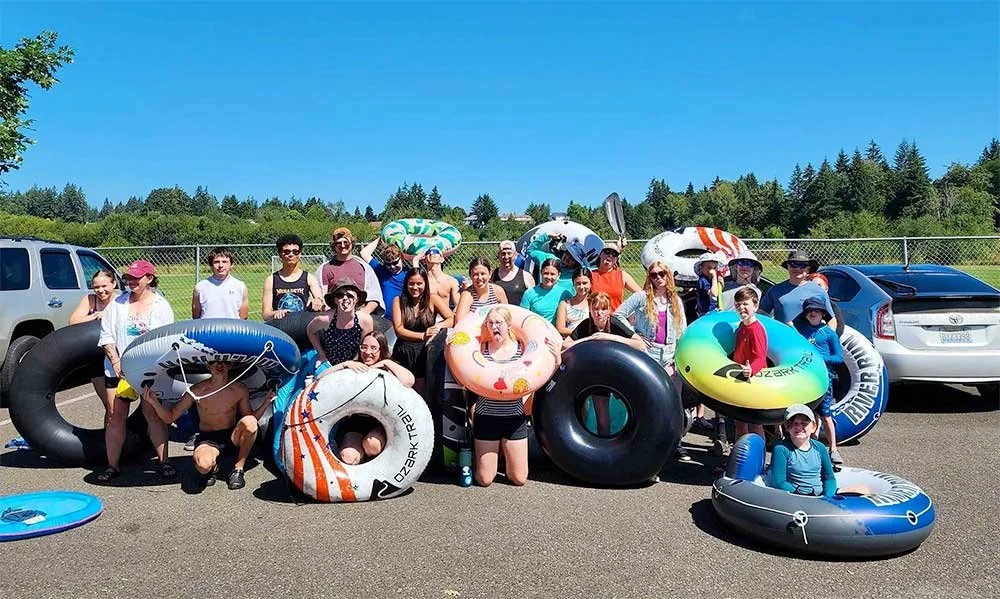 Group of Harbor Students holding innertubes outdoors