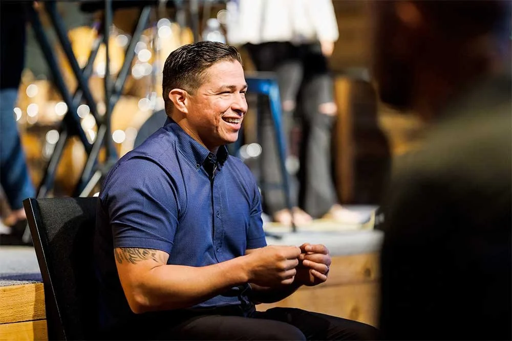 Smiling man sitting in church service