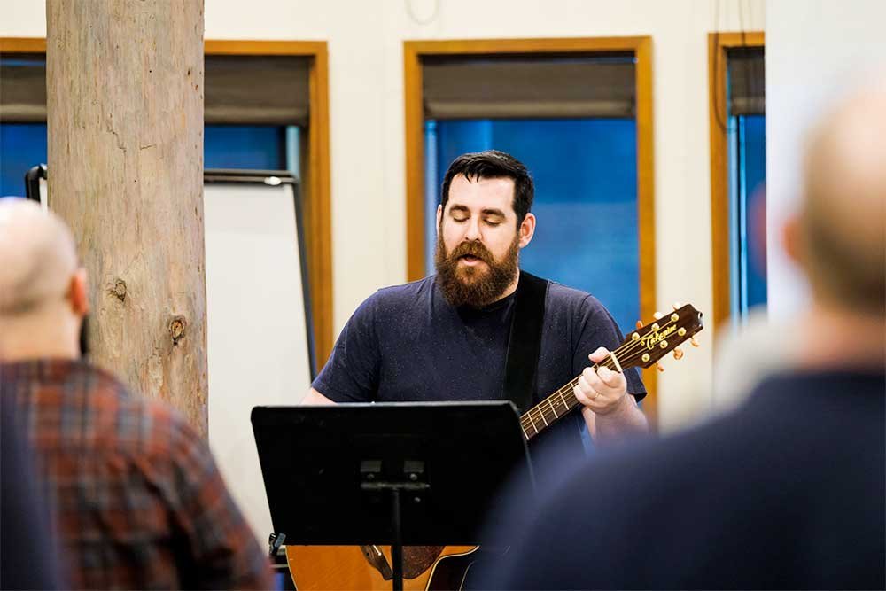 Man leading worship at a Harbor Men's event