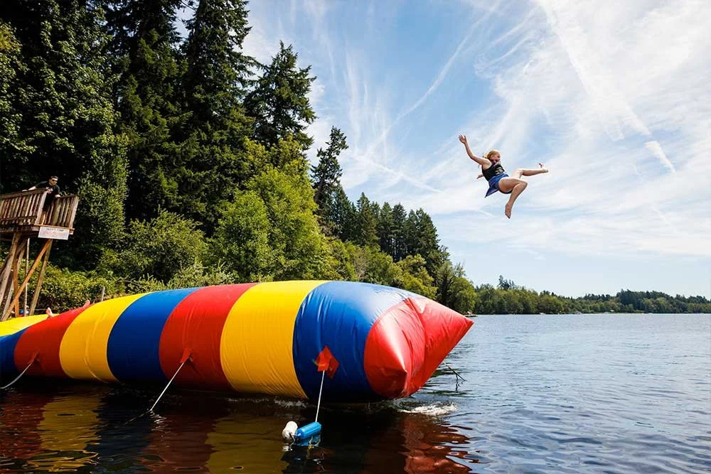 Child launched in the air from a giant lake inflateable 'blob'