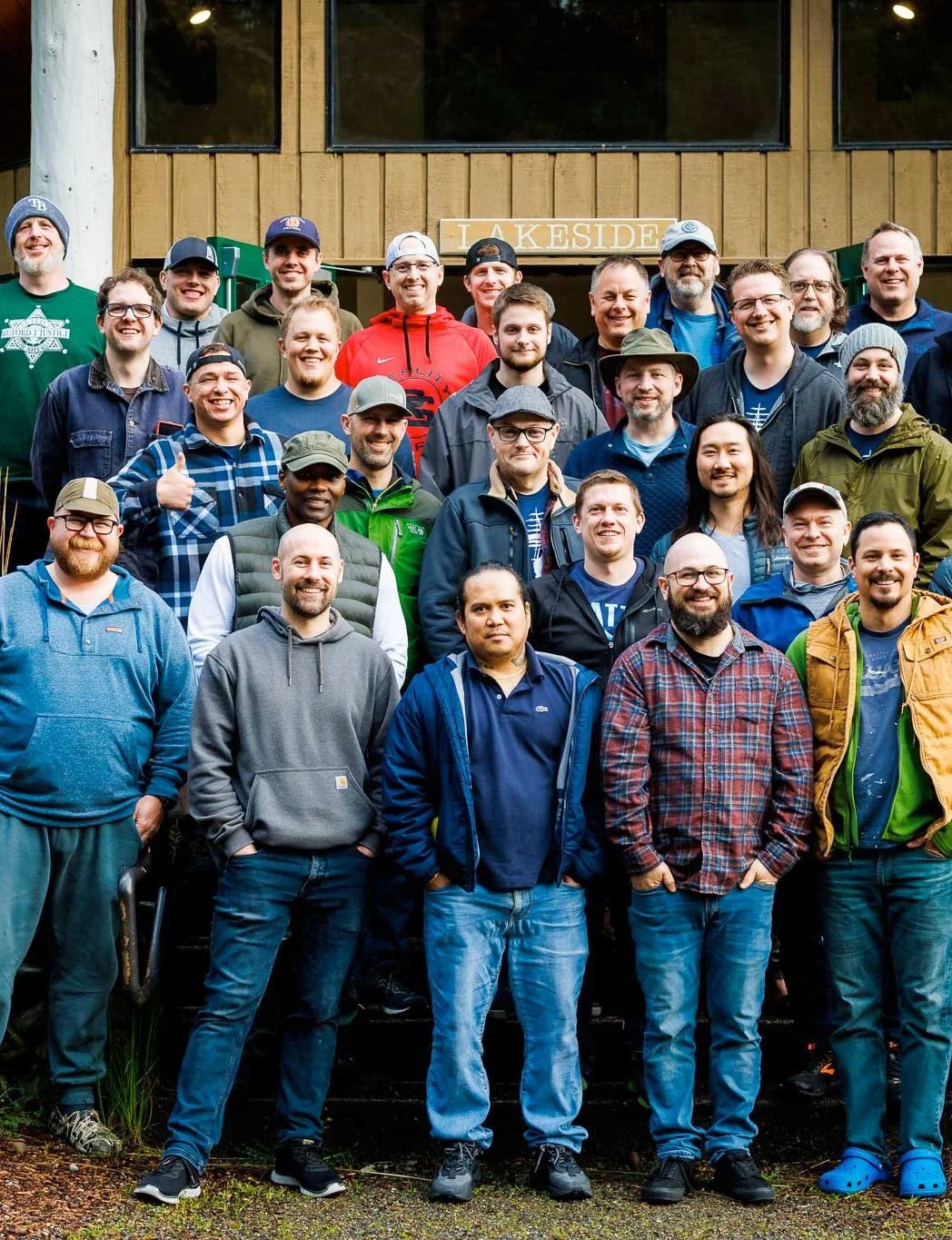 Group of men posing and smiling at a Men's event