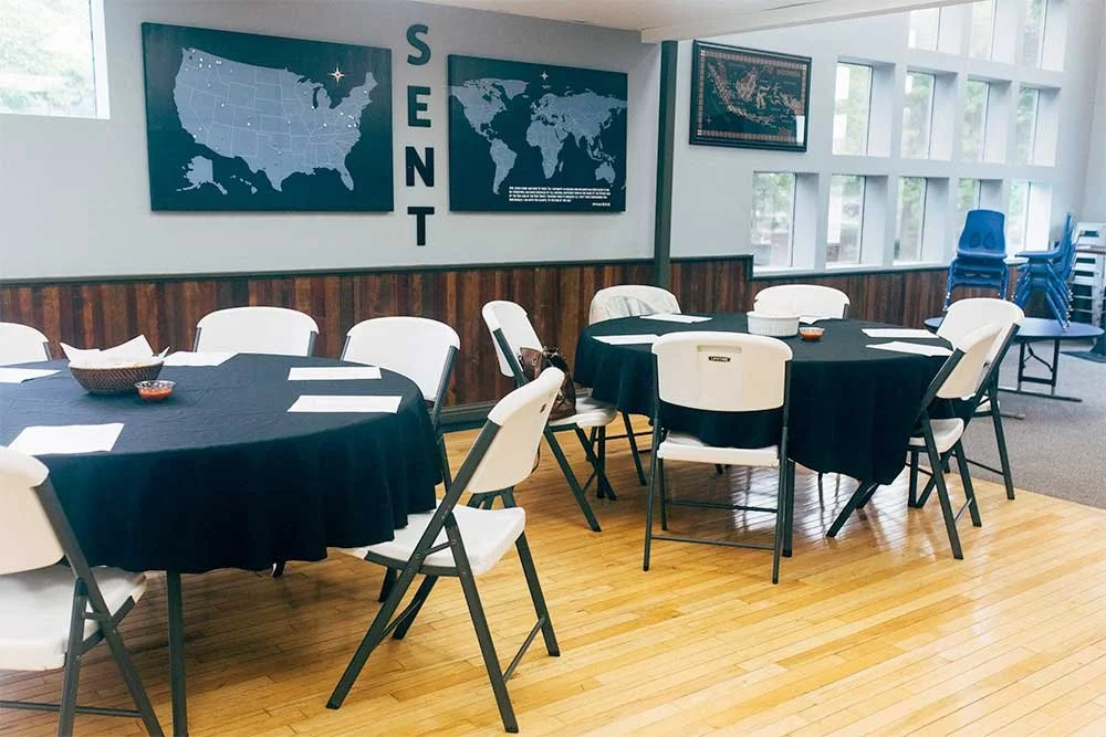 Harbor Church commons with table and chairs setup, empty